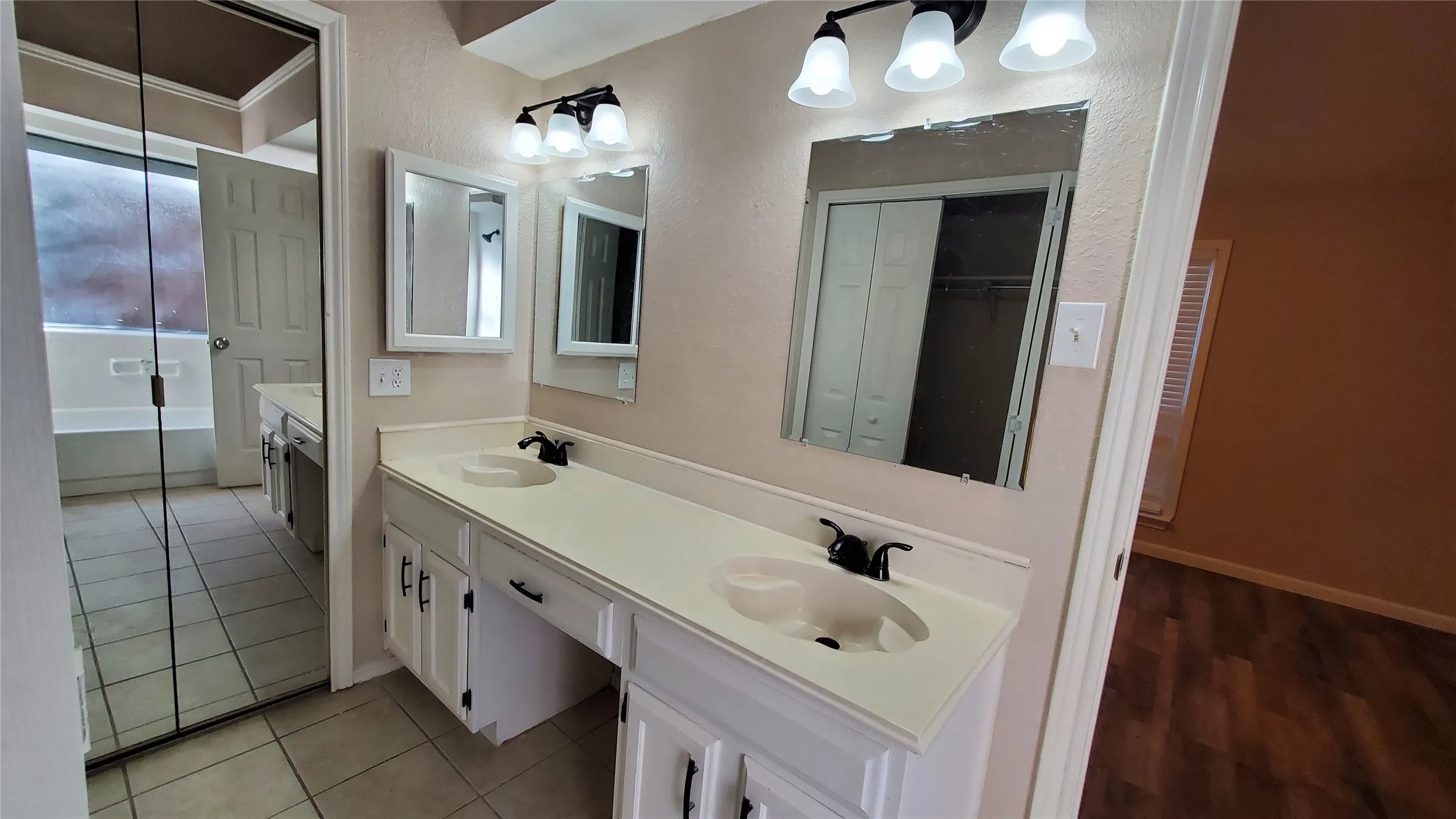 Bathroom featuring tile patterned floors and vanity