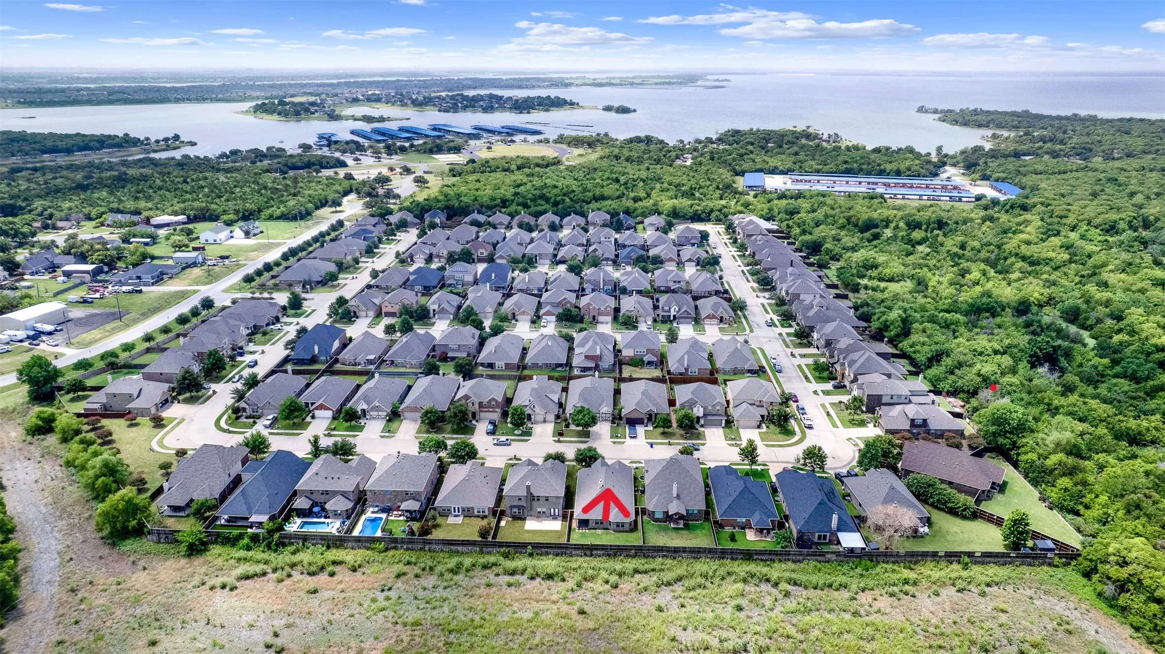 Residential community featuring uniform single-family homes with gray roofing