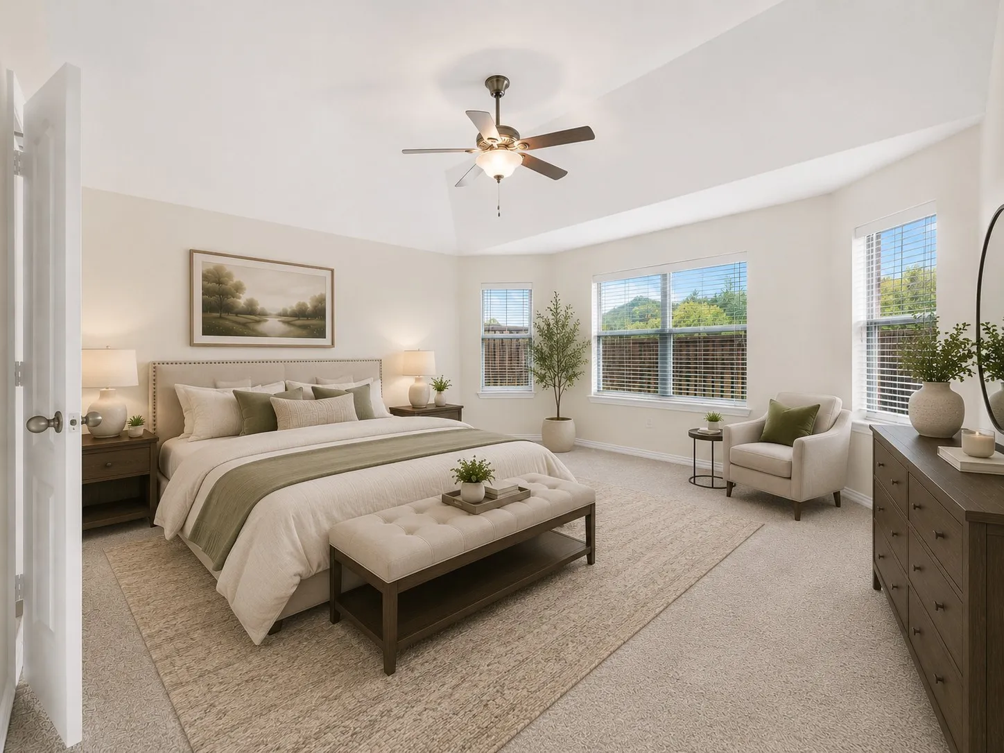 Spacious room featuring vaulted ceilings, a ceiling fan, and multiple windows providing ample natural light