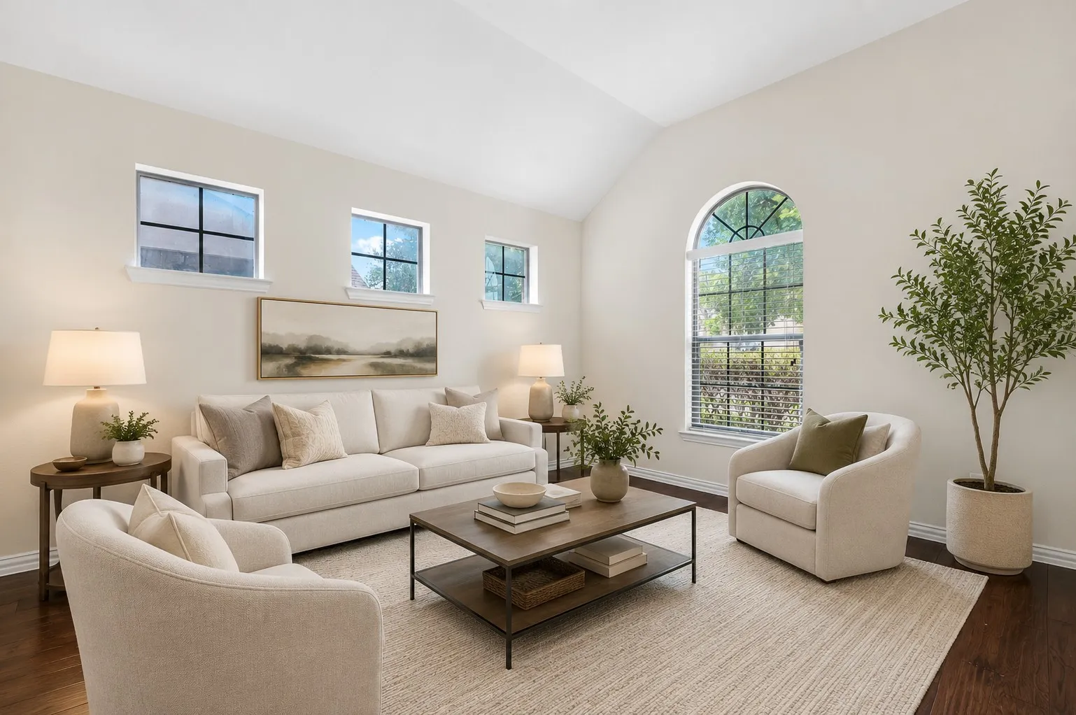Vaulted ceiling living space with wood-finish flooring
