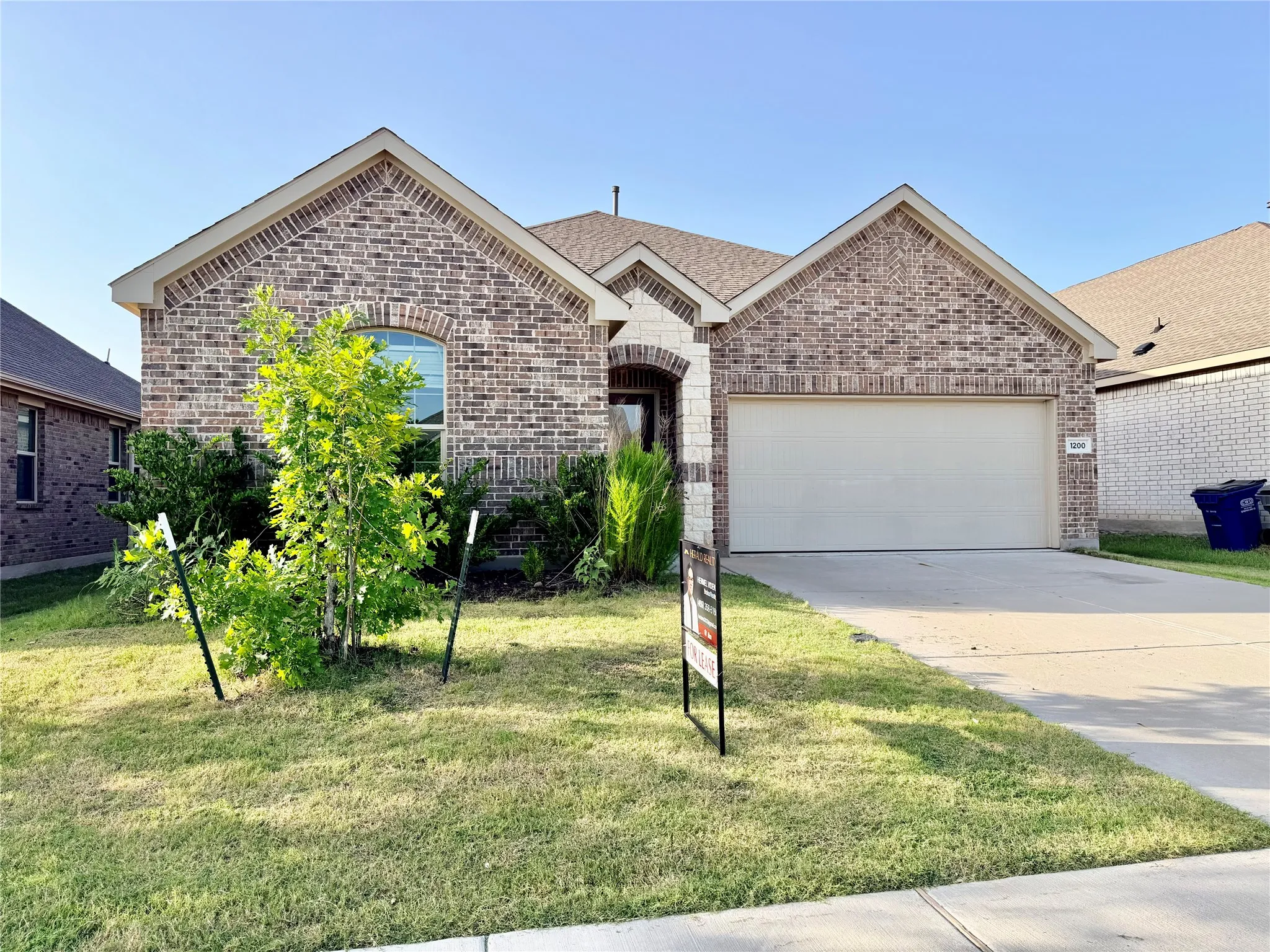 Brick and stone veneer exterior with a two-car garage