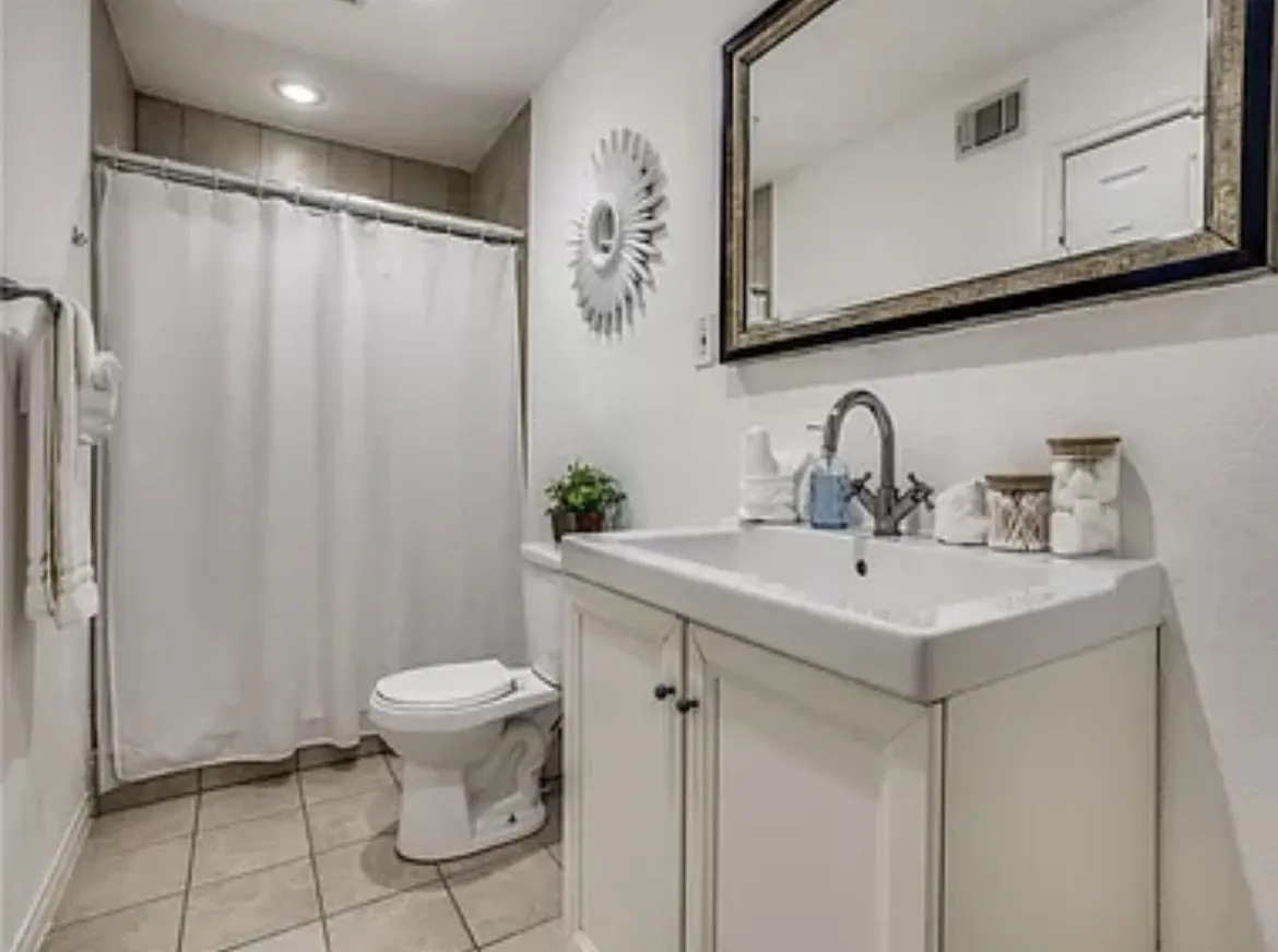 Bathroom with tile floors, vanity, and toilet