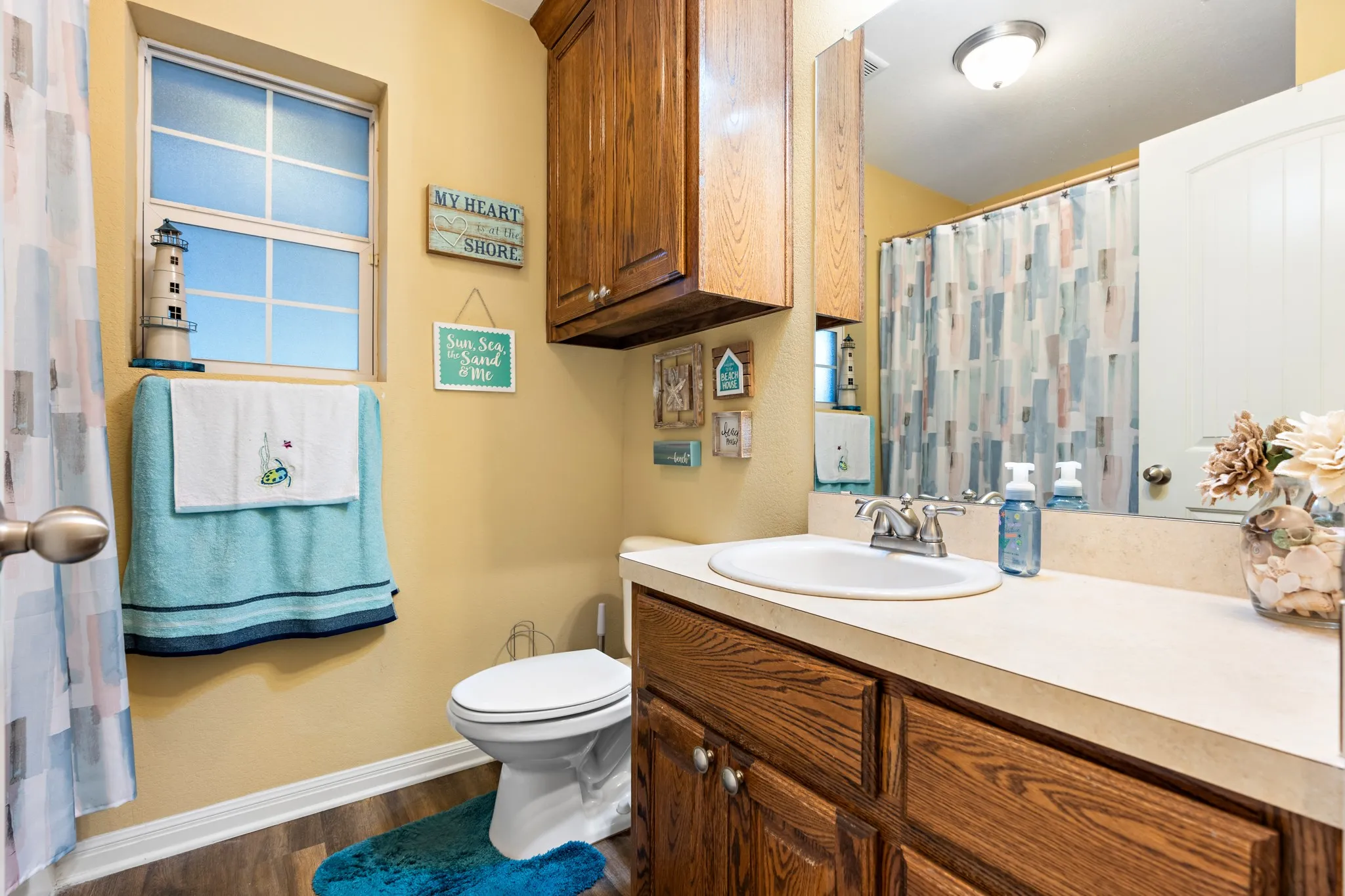 Bathroom featuring a vanity with a laminate countertop, integrated sink, and an overhead medicine cabinet