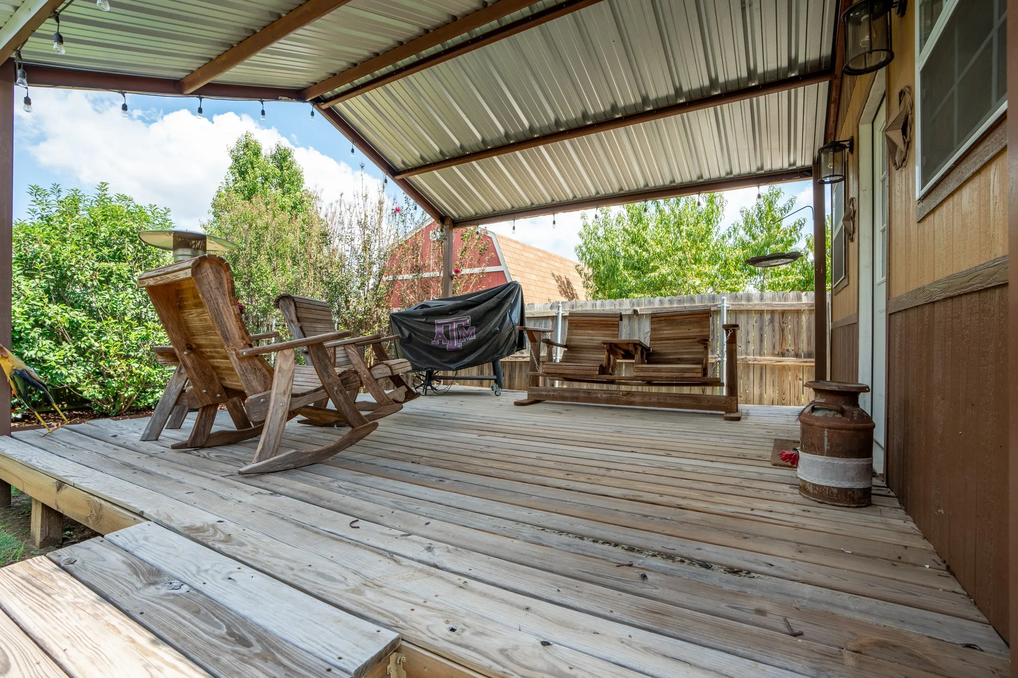 Expansive wooden deck with a durable metal roof covering