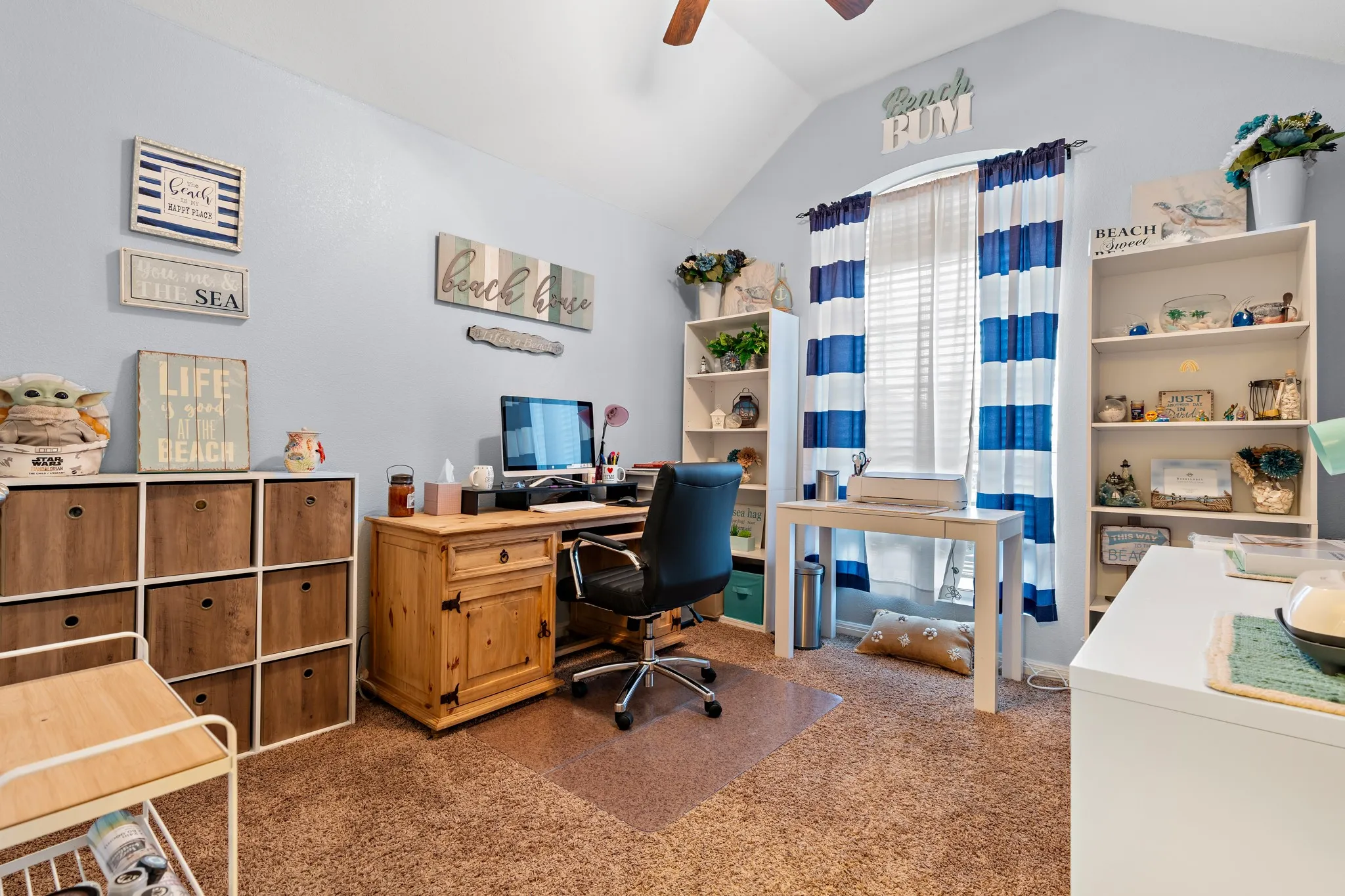 Vaulted ceiling room with textured carpet flooring