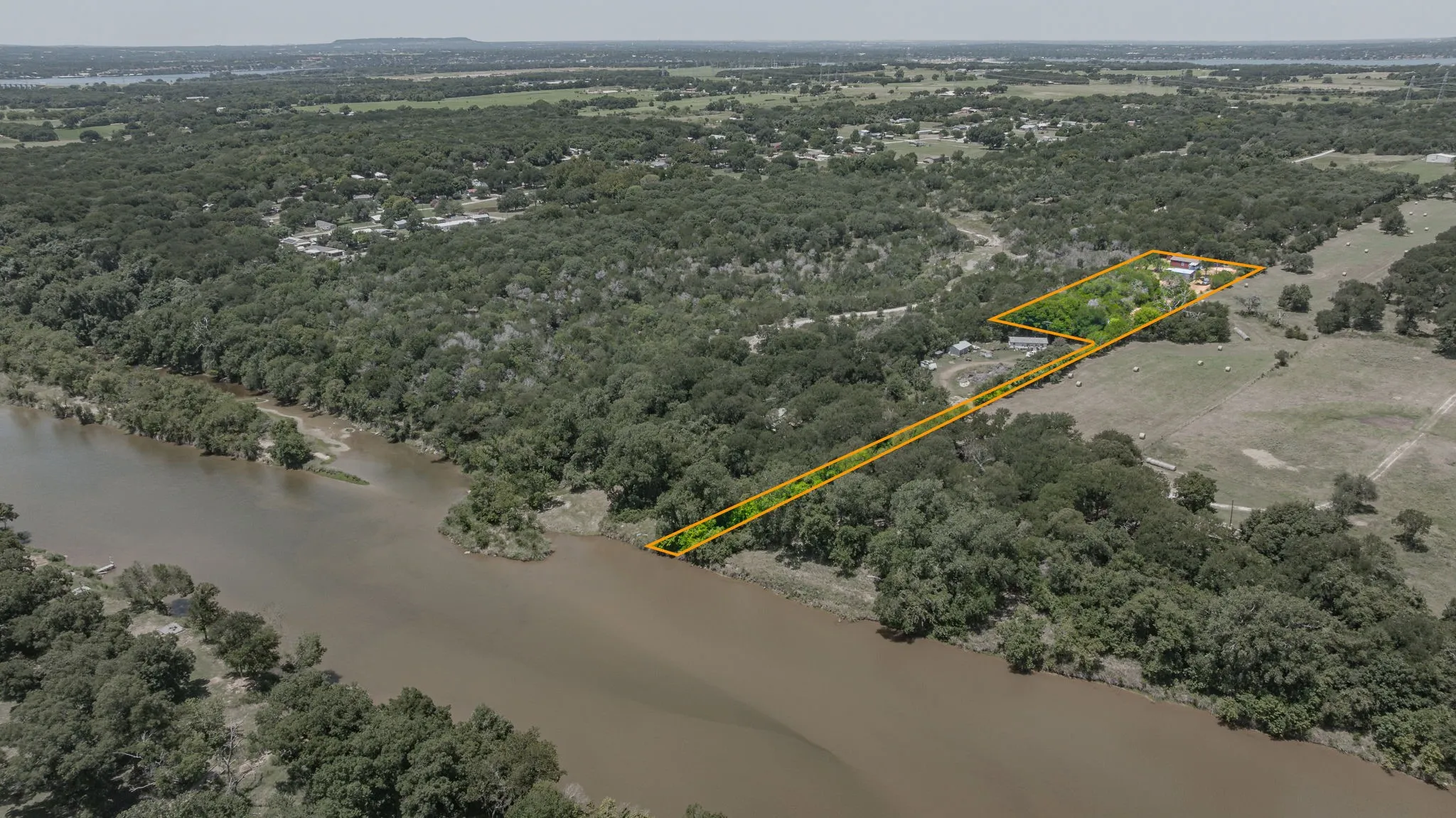 Expansive property featuring significant waterfrontage along a wide river