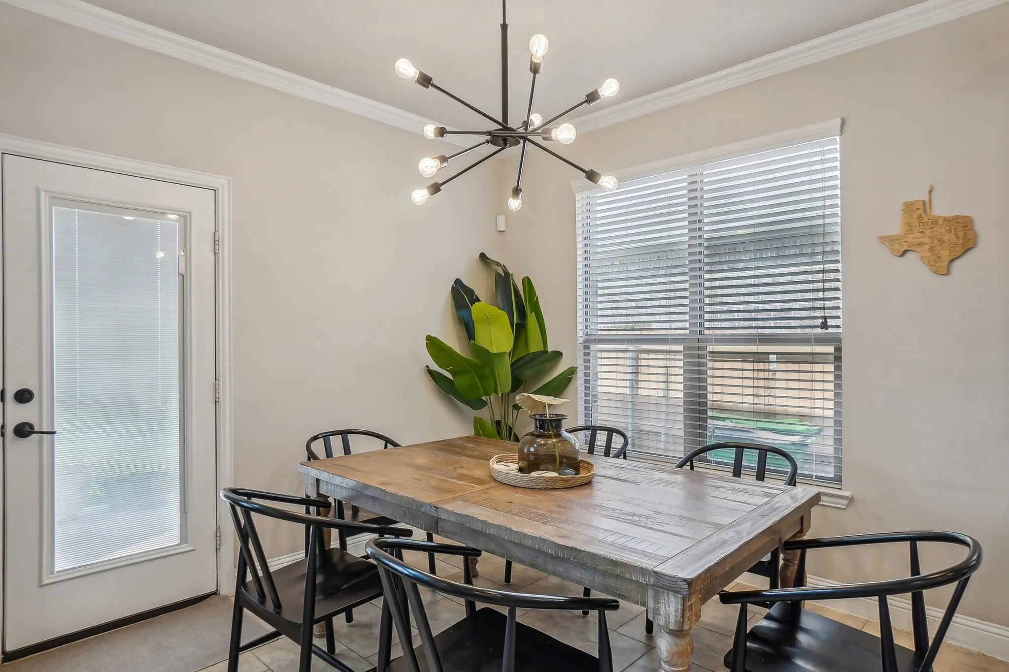 Dining space featuring crown molding and a chandelier