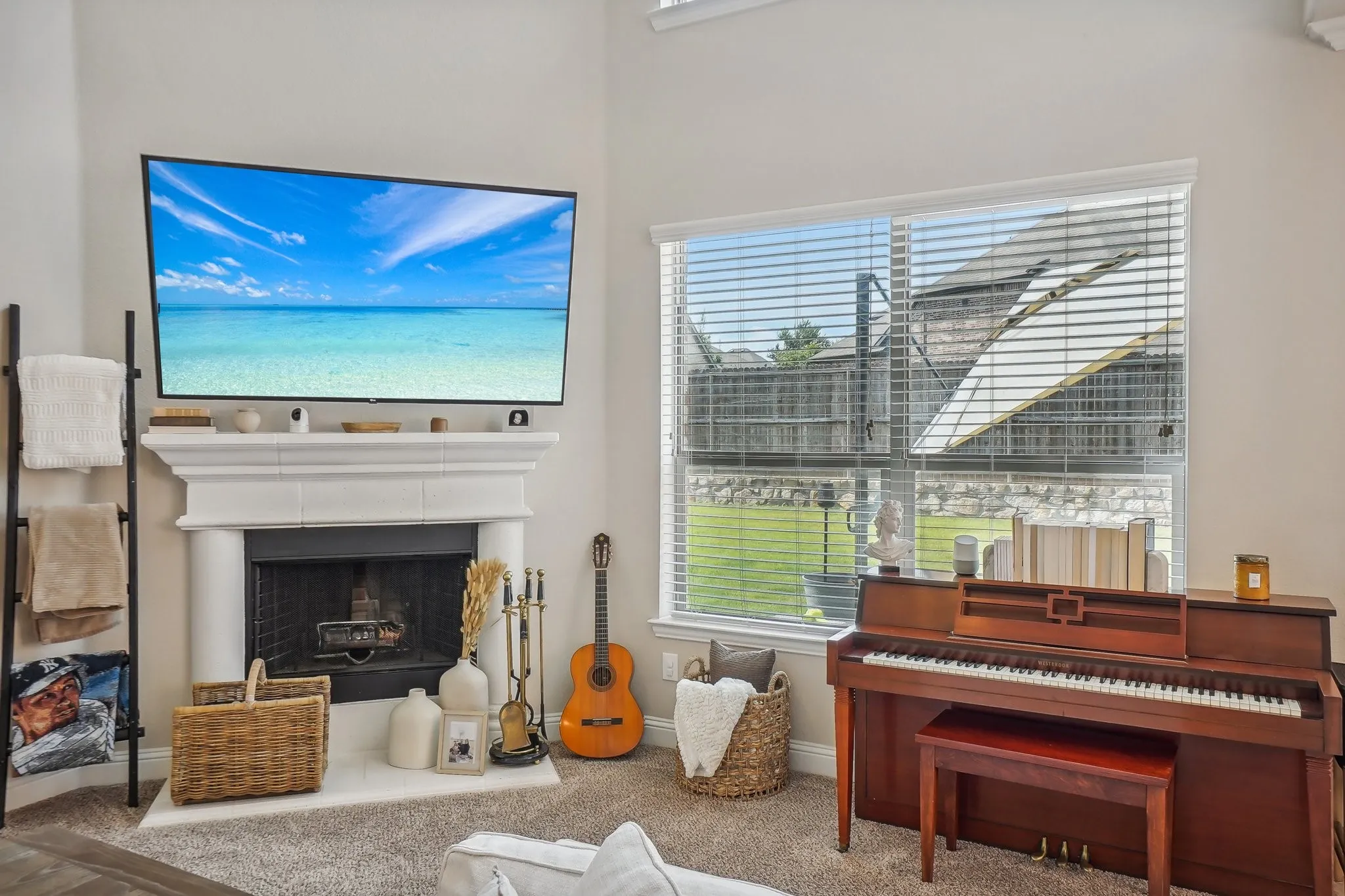 Living area featuring a fireplace with raised hearth and carpet