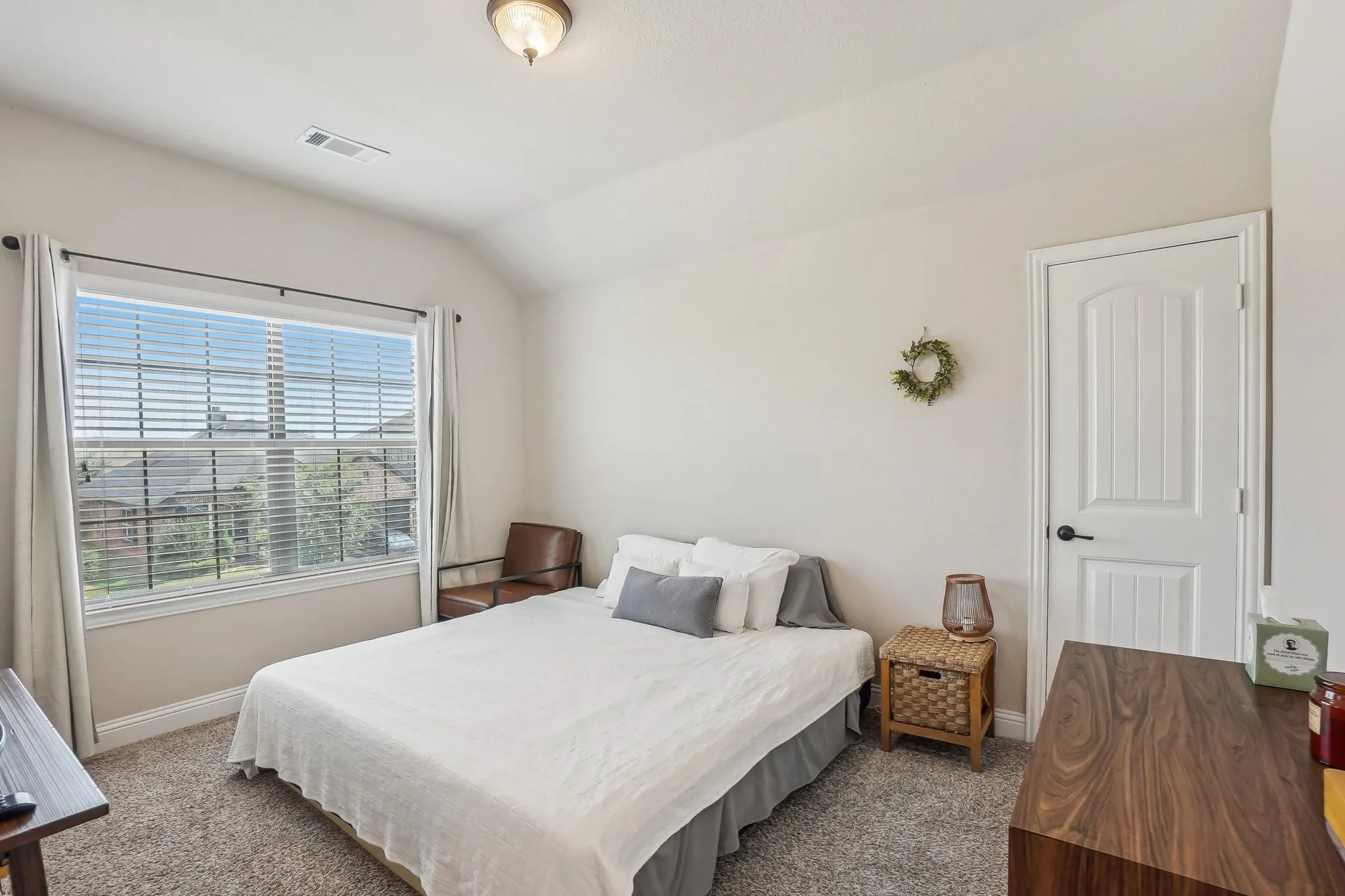 Carpeted bedroom with baseboards and lofted ceiling