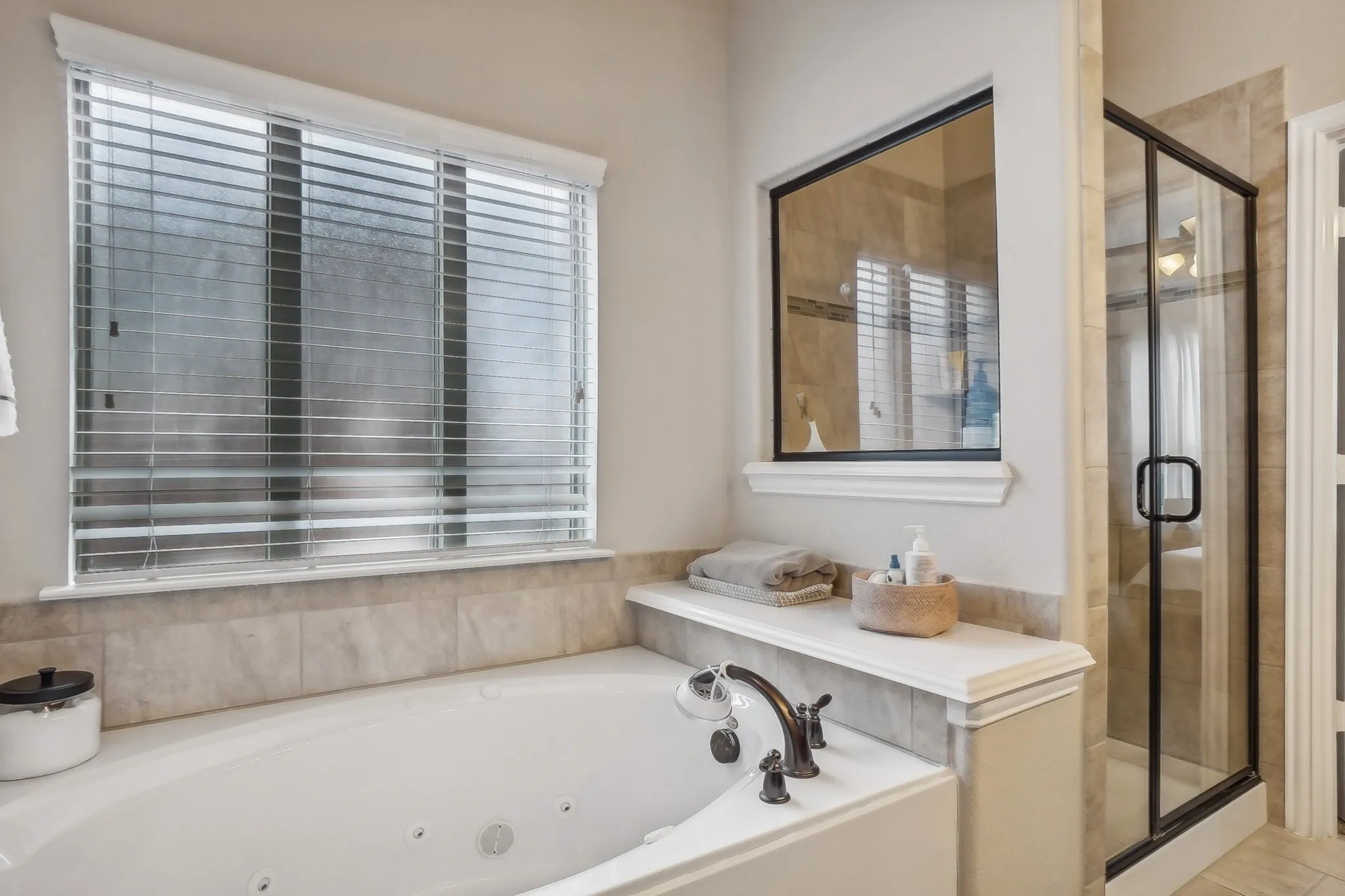 Full bathroom featuring a jetted tub and a shower stall