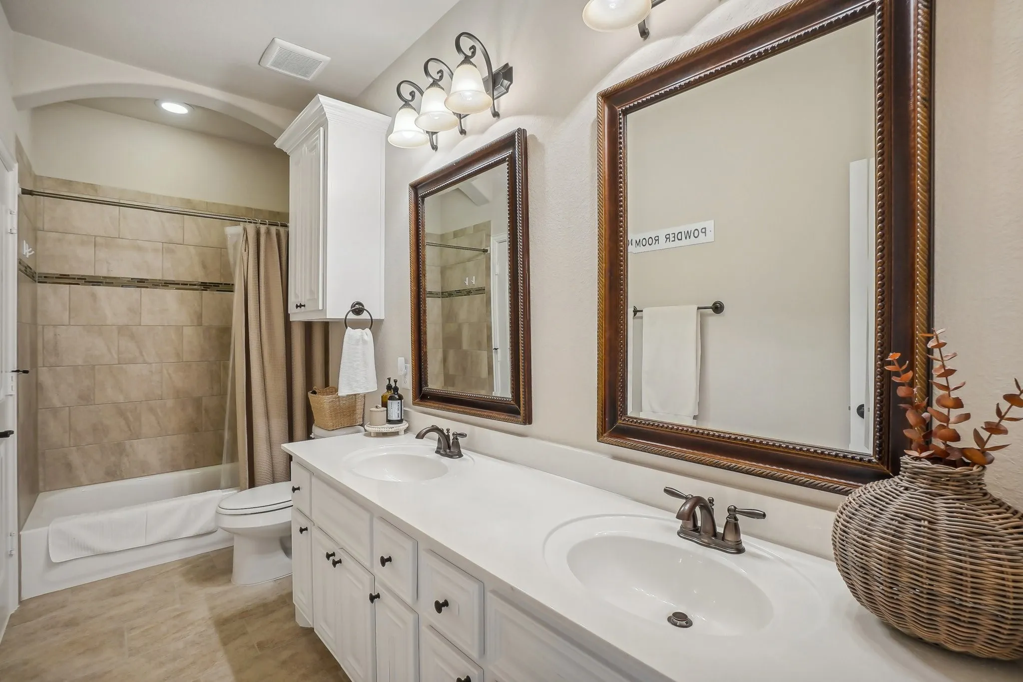 Full bathroom with shower / bath combo and double vanity