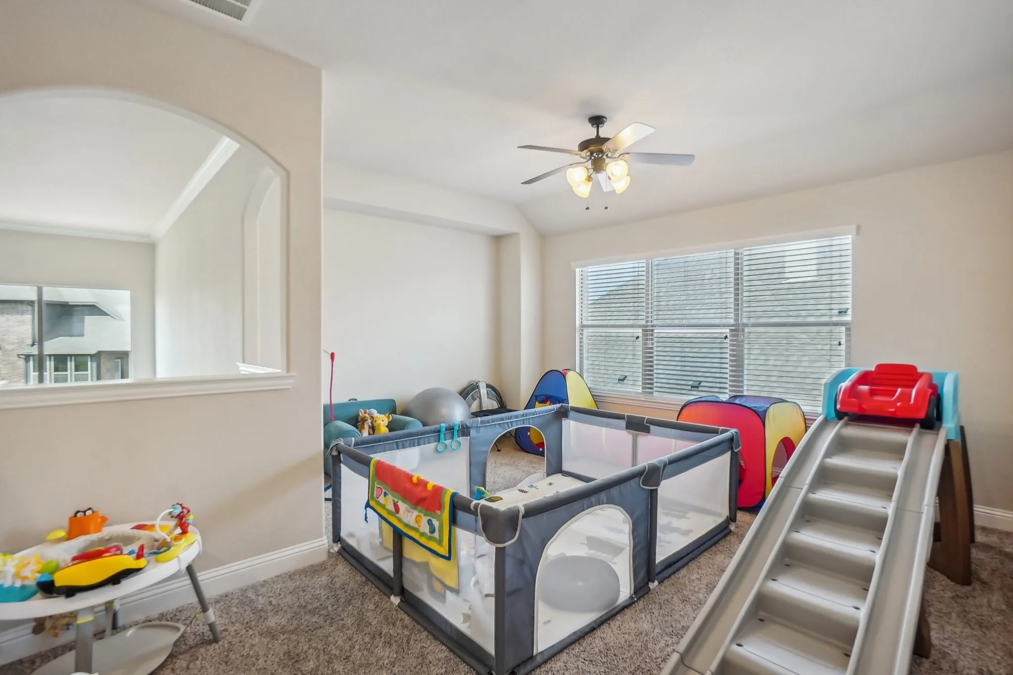 Game room with carpet and ceiling fan