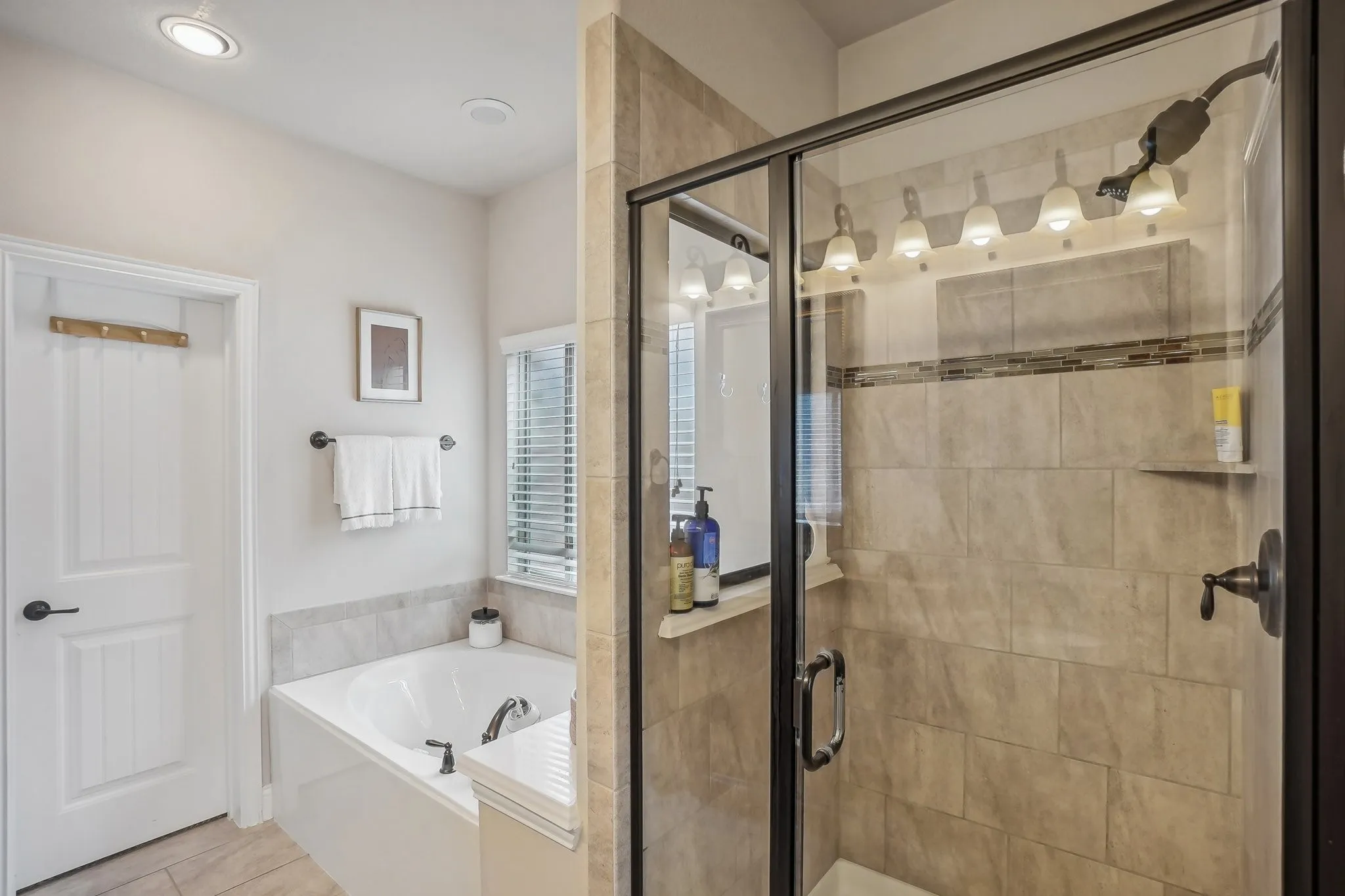 Full bathroom with a garden tub, a shower stall, and tile patterned floors