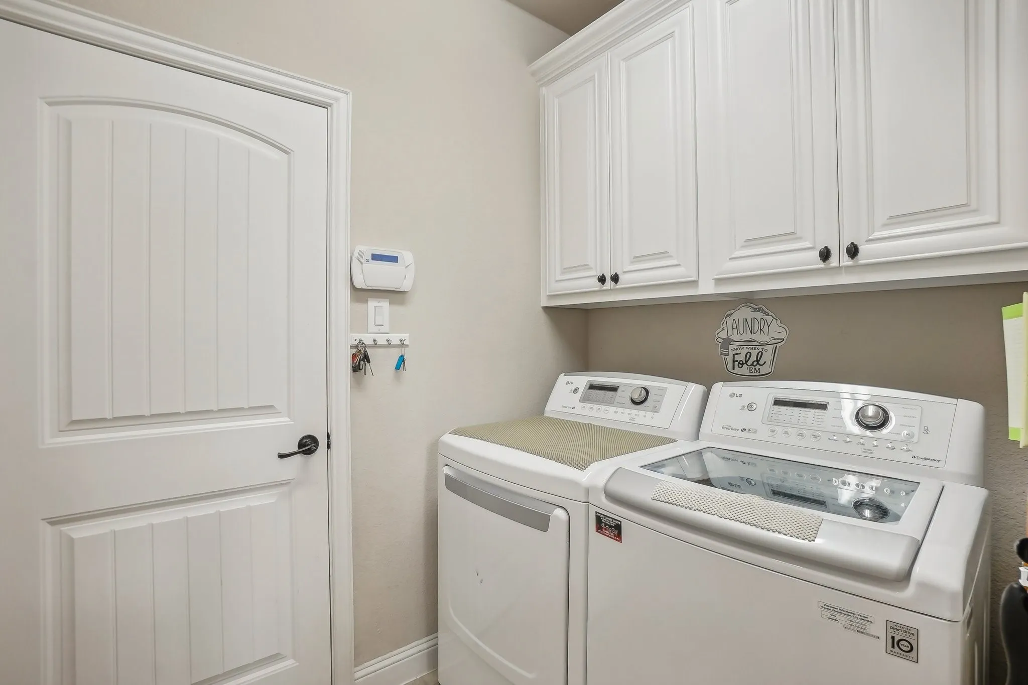 Laundry area featuring washer and dryer and cabinet space