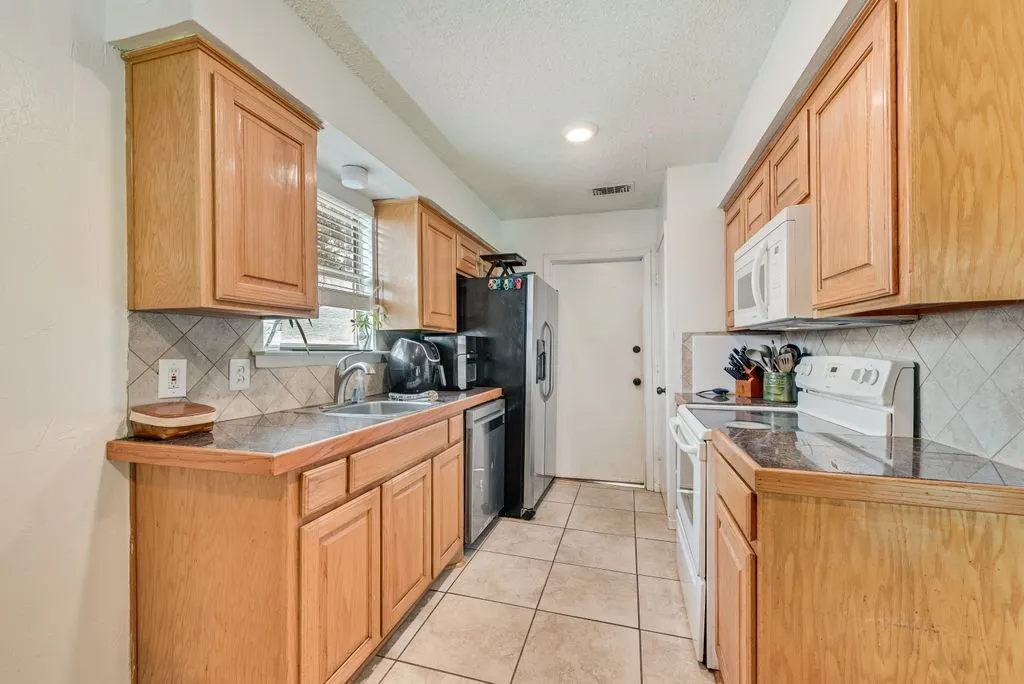 The door leads to the garage which is where the washer/dryer connections are