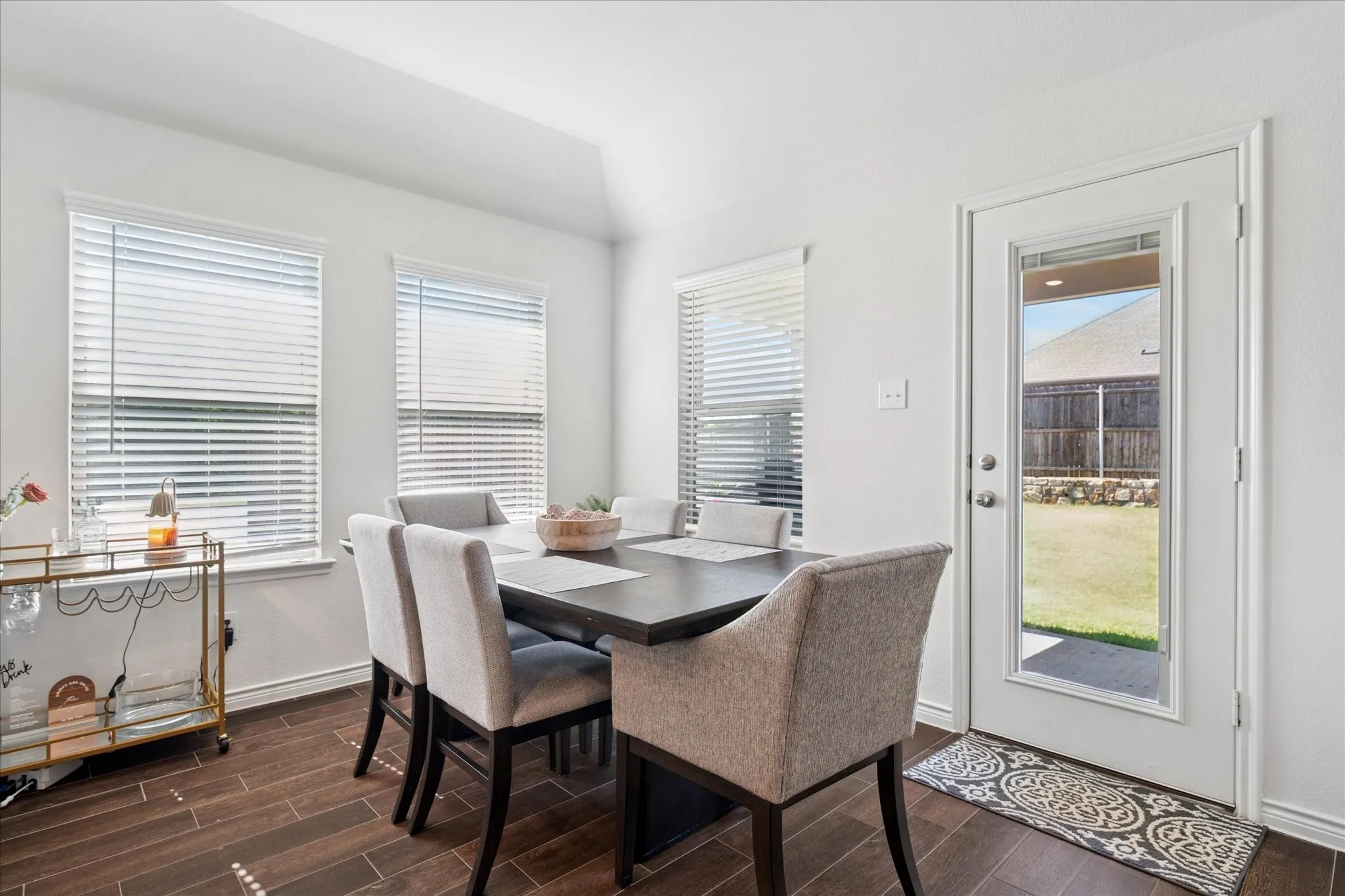 Dining area featuring wood-finish flooring and a vaulted ceiling