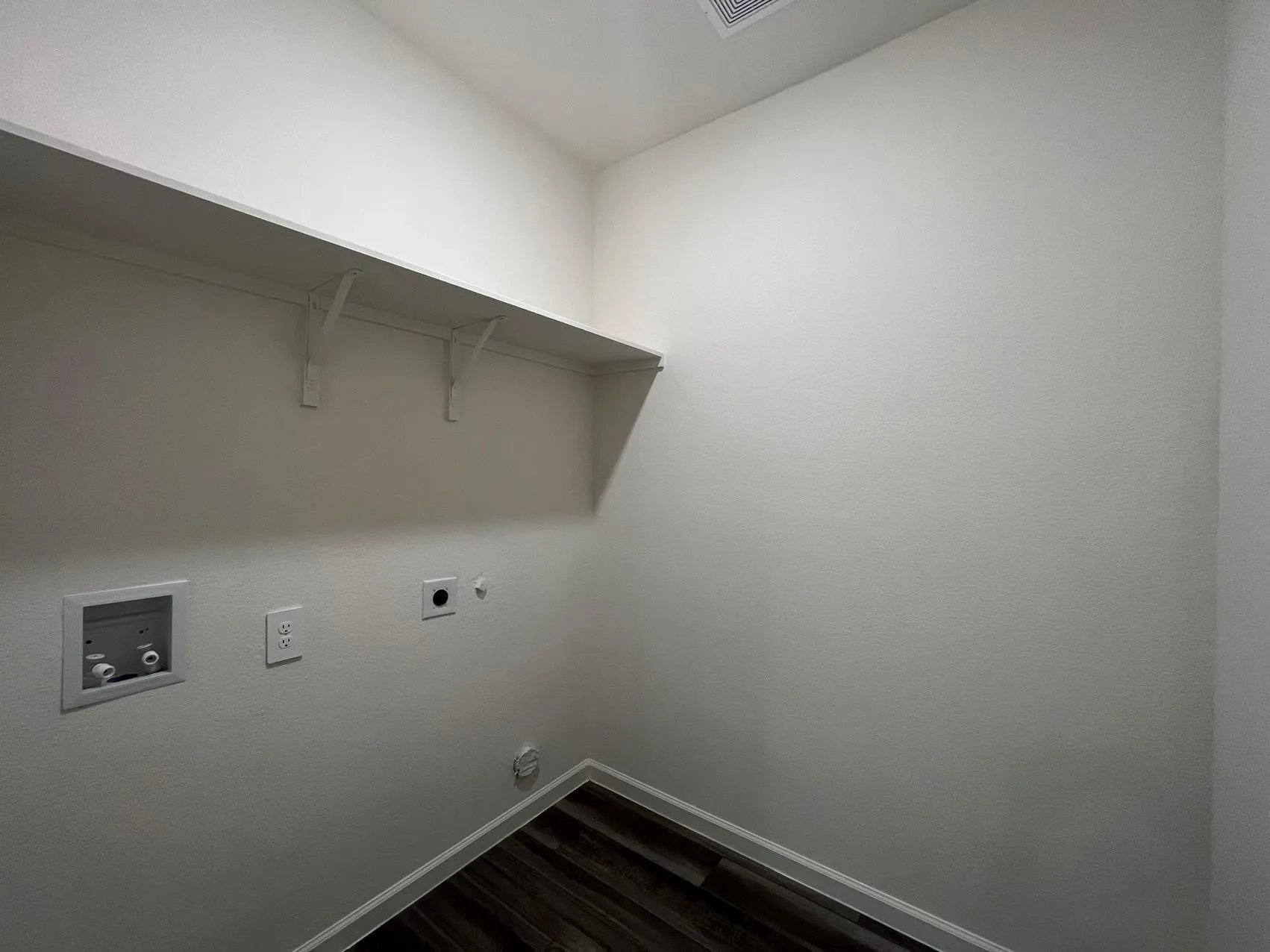 Laundry room with dark wood finished floors, electric dryer hookup, washer hookup, and gas dryer hookup
