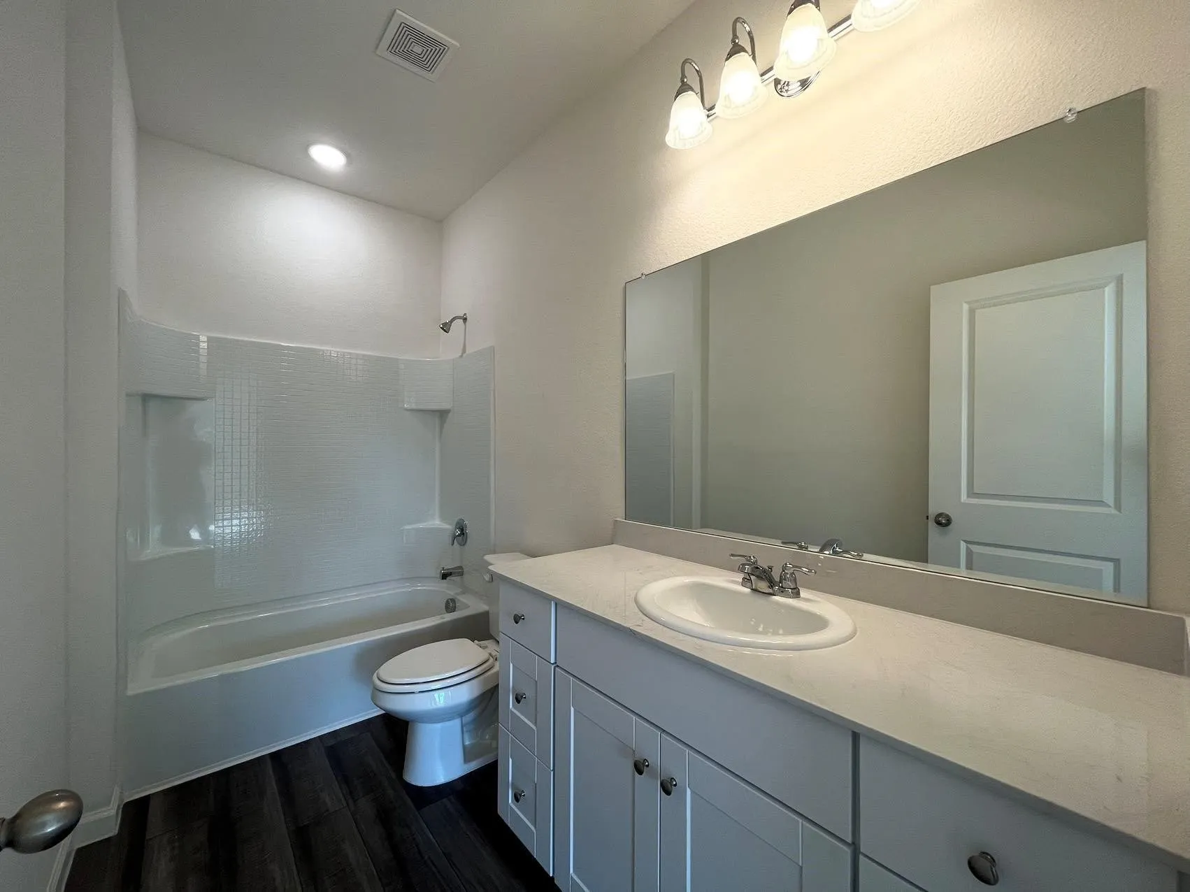 Bathroom with  shower combination, vanity, and dark wood-style floors