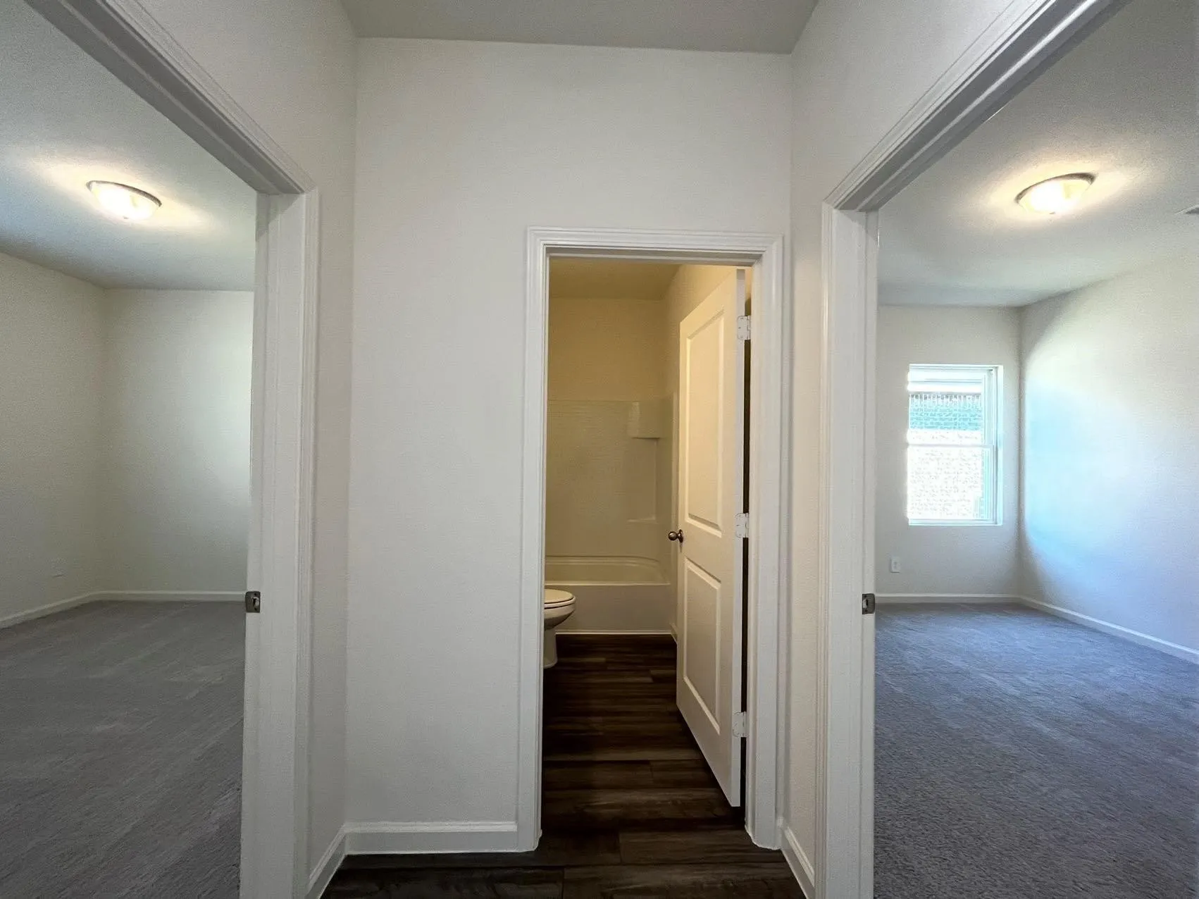 Hallway with dark colored carpet