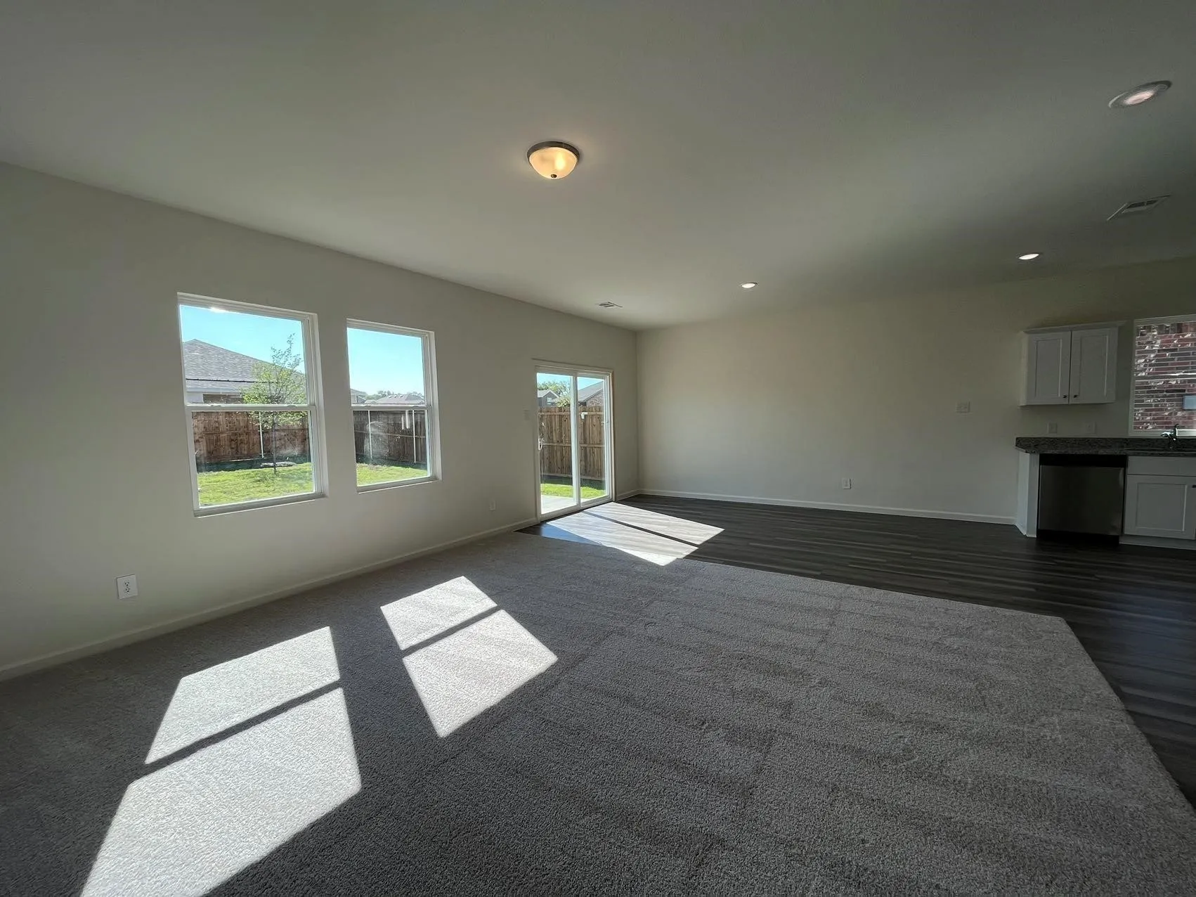 Unfurnished living room featuring healthy amount of natural light and recessed lighting