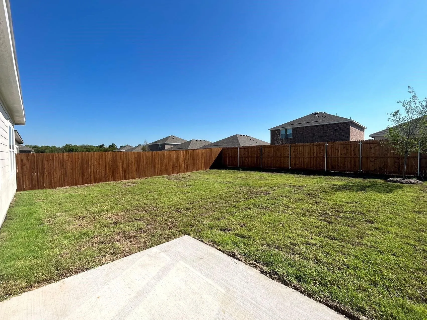 Fenced backyard with a patio