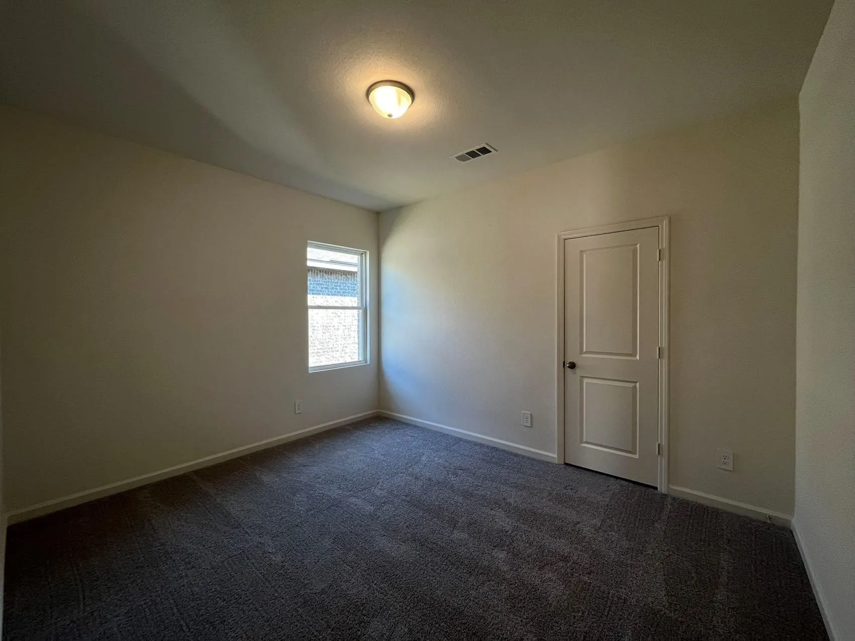 Spare room with dark carpet