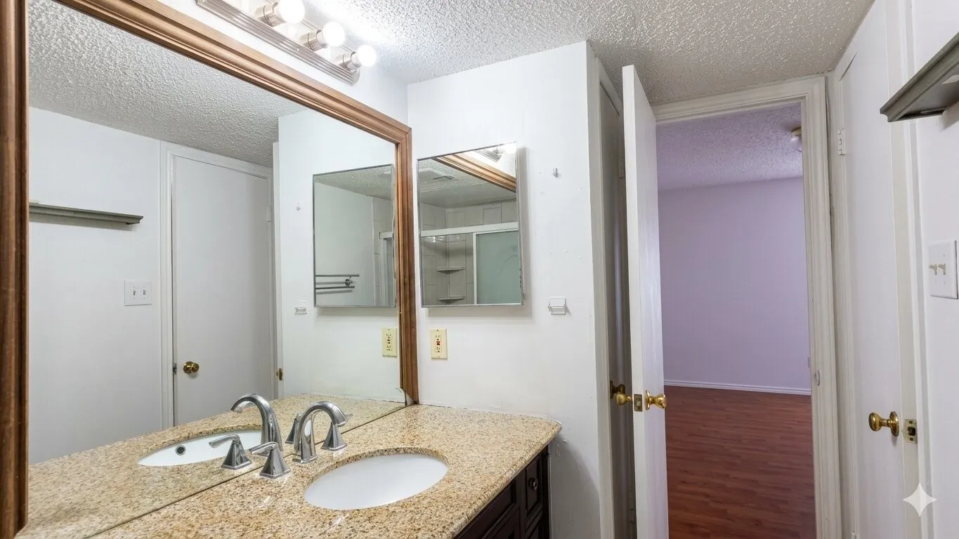 Dual vanity with light-toned countertop, undermount sinks, and chrome faucets