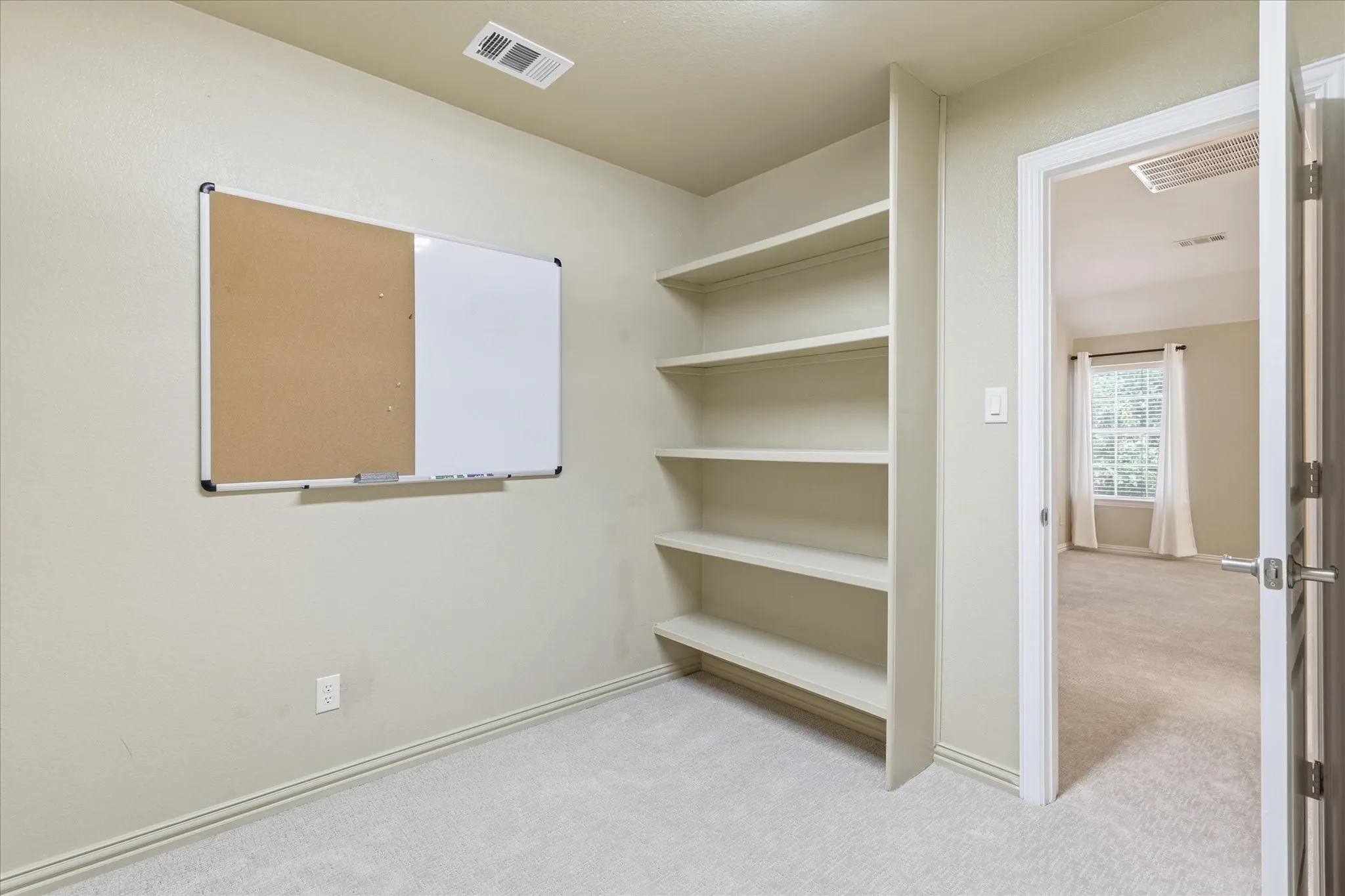 storage closet or hobby room with access to floored attic