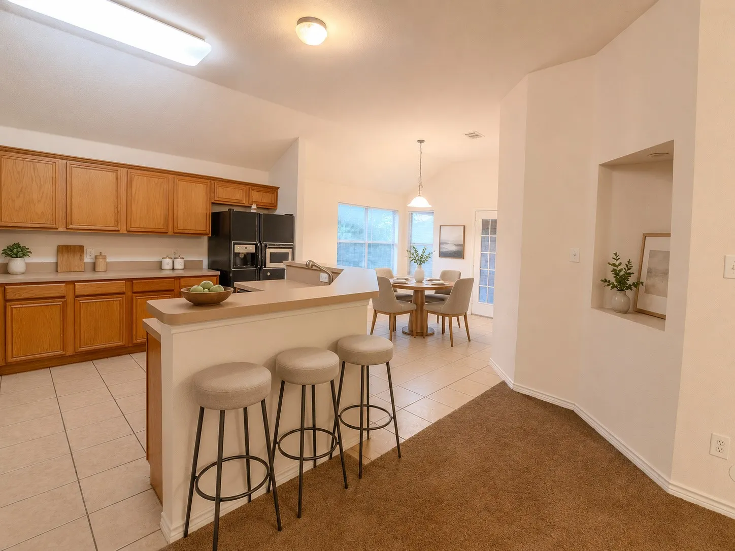 Virtually Staged Kitchen featuring wood cabinetry, integrated appliances, and tile flooring