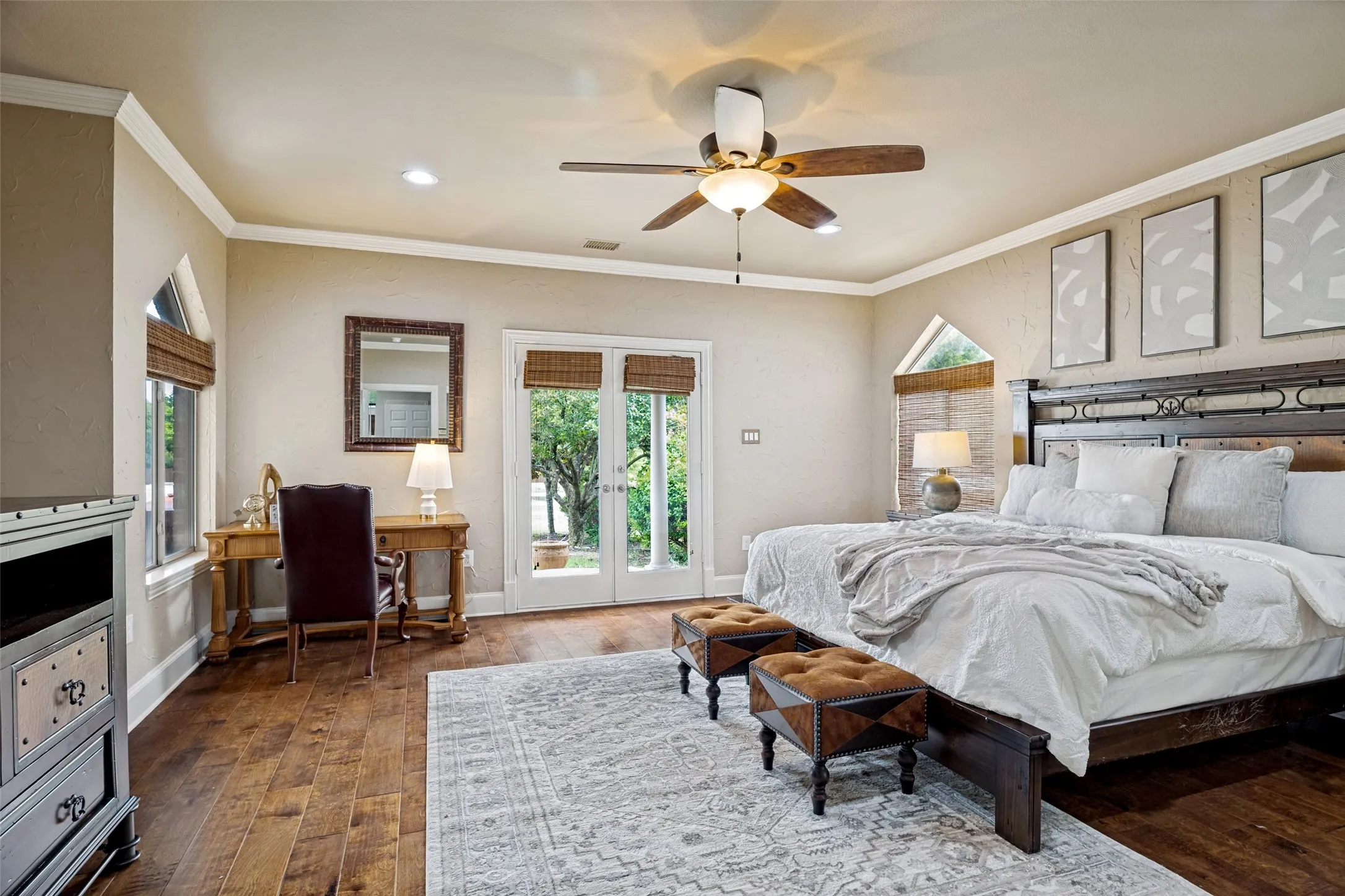 Spacious room with wood-finish flooring, crown molding, and recessed lighting