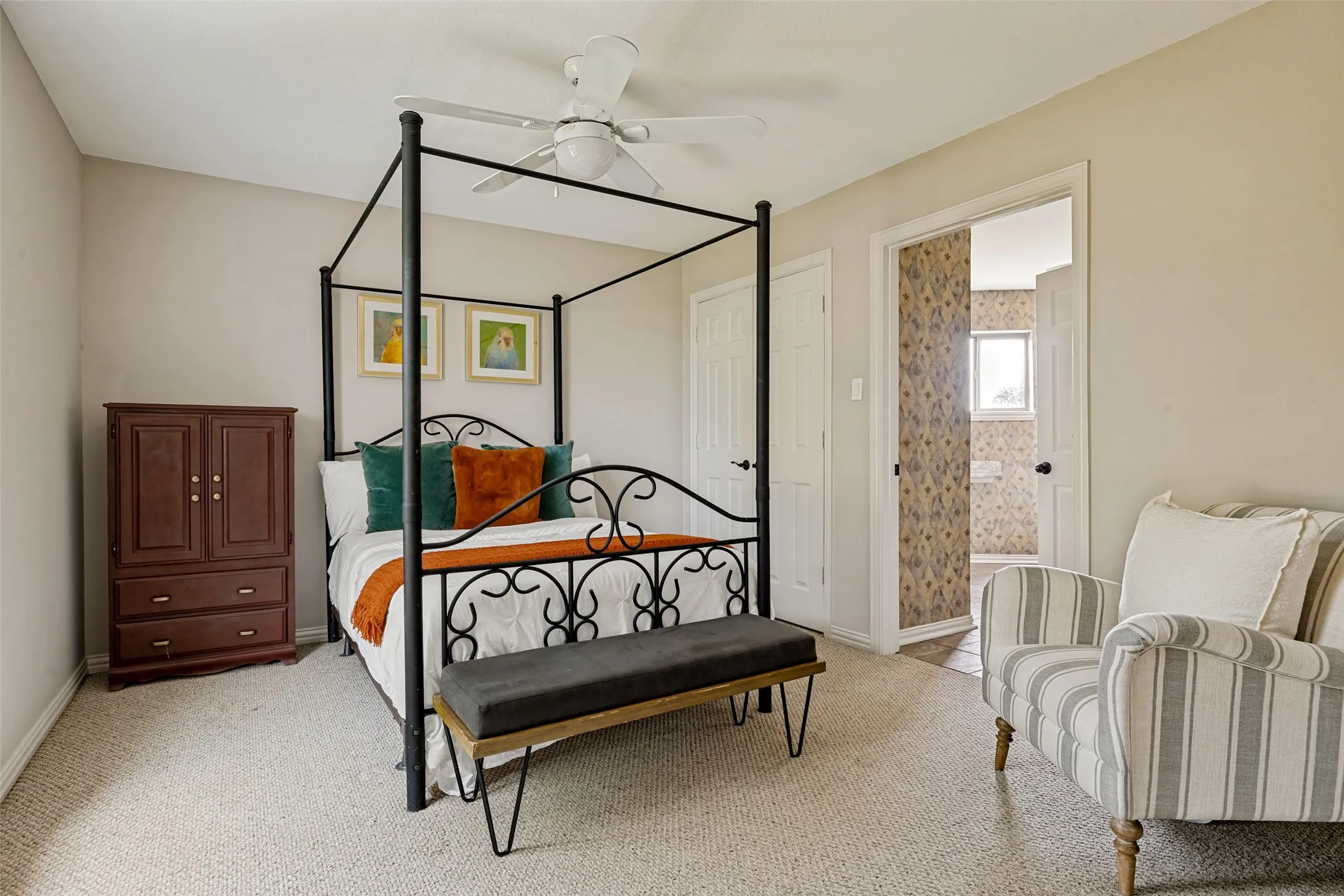 Carpeted room with a ceiling fan, light-toned walls, and white trim