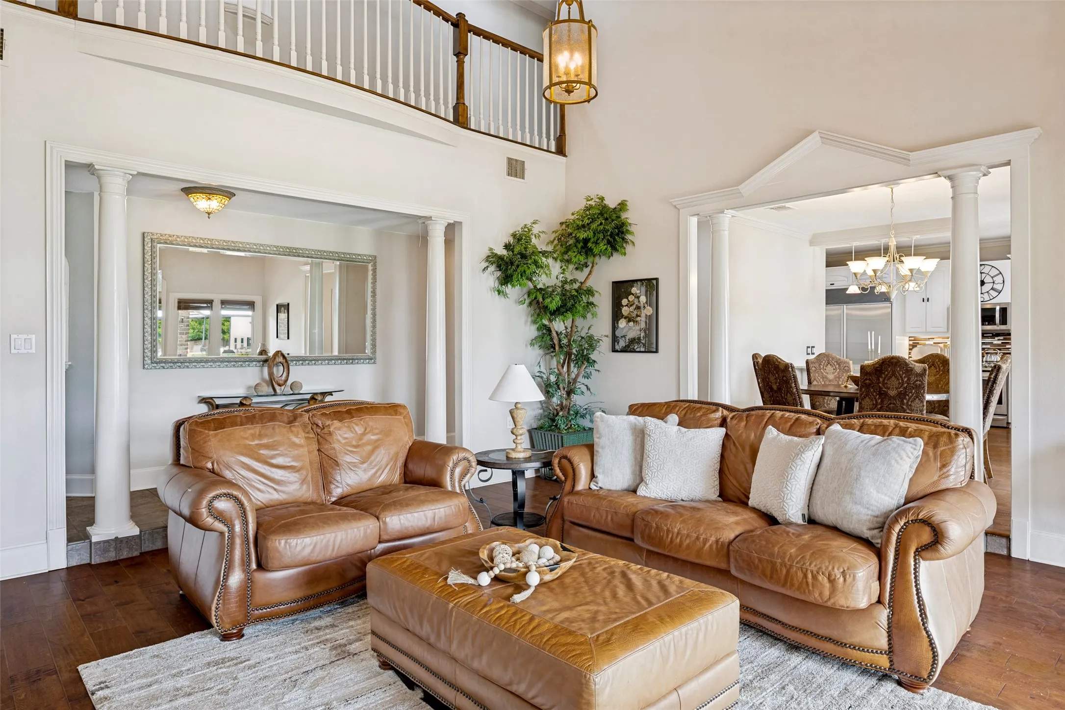 Living area featuring high ceilings with a second-story balcony
