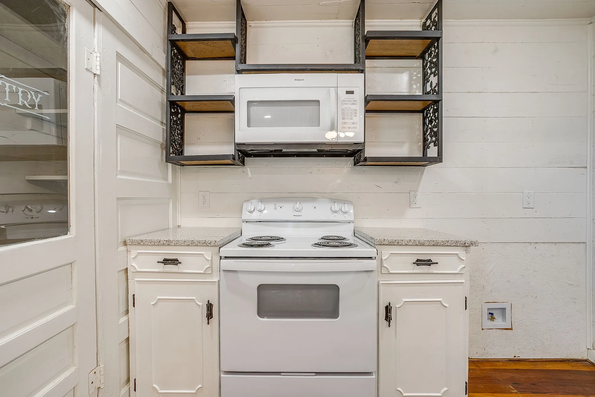 Kitchen featuring white appliances, white cabinetry, open shelves, and dark wood-style floors