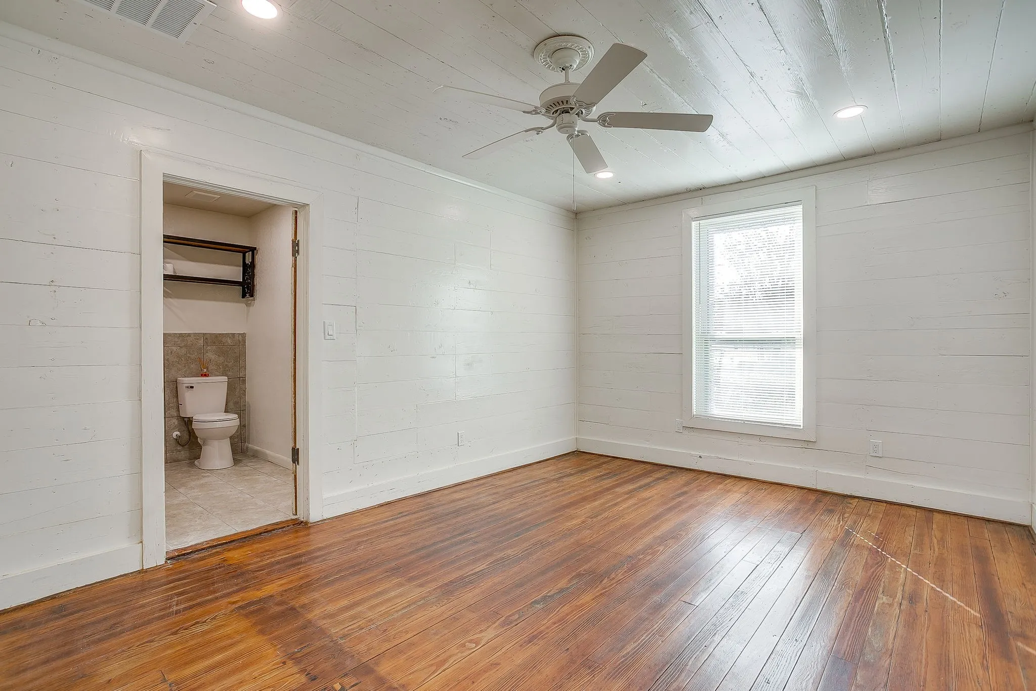Unfurnished bedroom featuring wood-type flooring, a ceiling fan, wood ceiling, recessed lighting, and ensuite bathroom