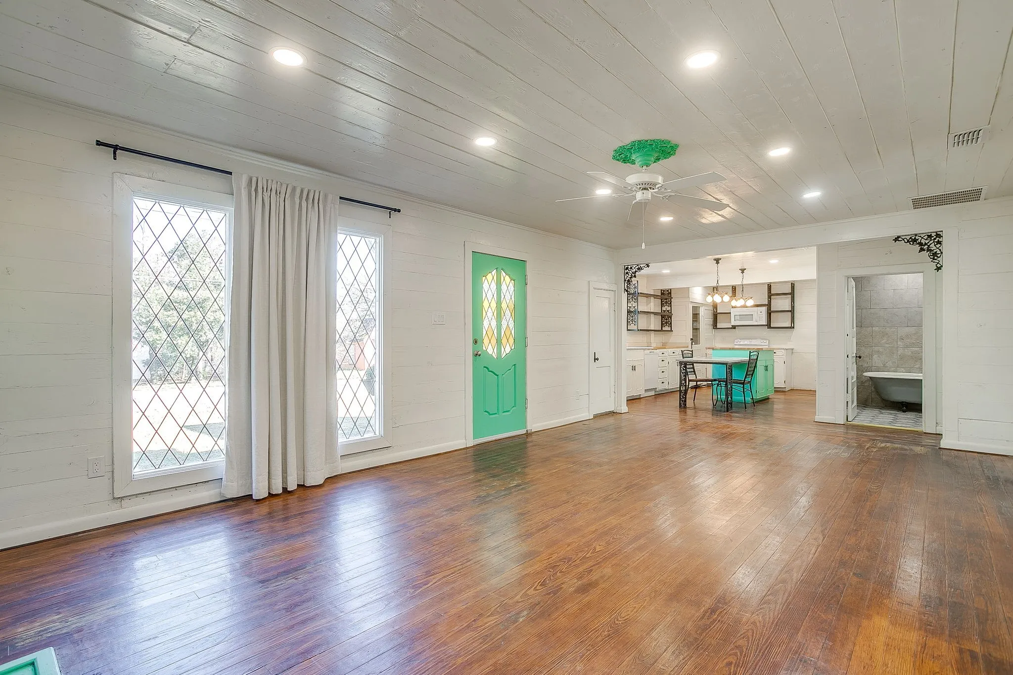 Unfurnished living room featuring wood ceiling, recessed lighting, dark wood-type flooring, wooden walls, and a chandelier