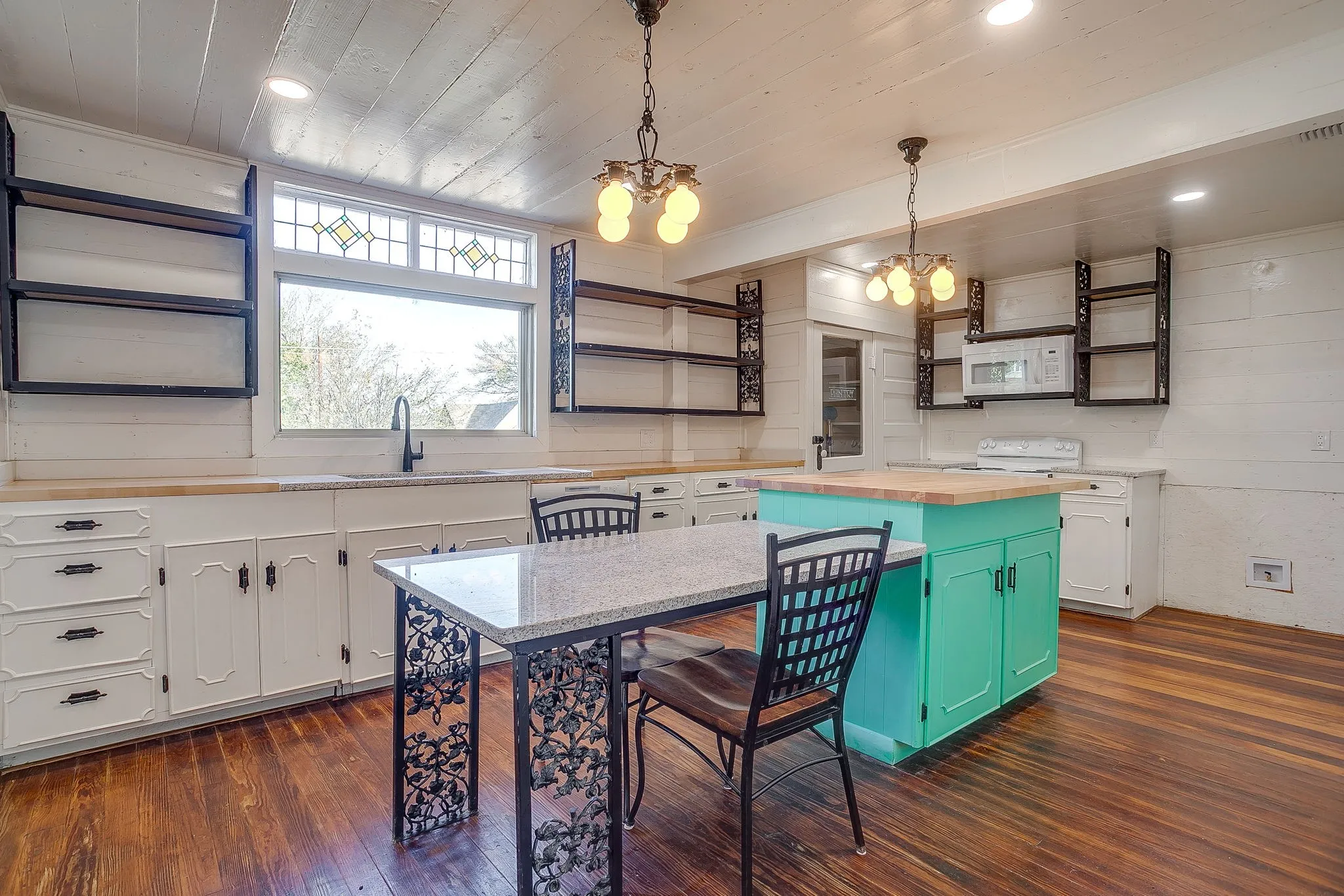 Kitchen featuring open shelves, butcher block counters, wood ceiling, white cabinets, and pendant lighting