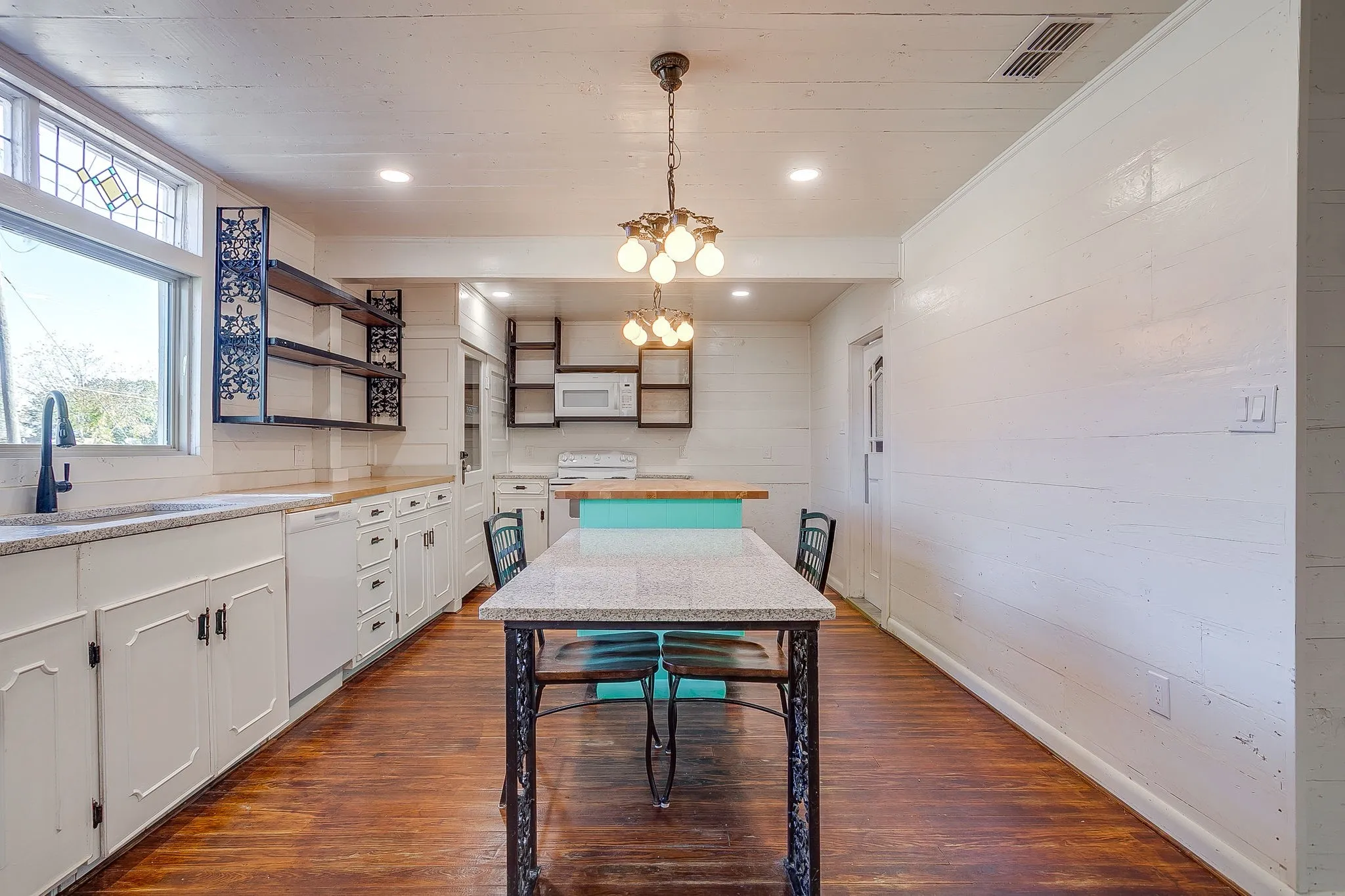 Dining space featuring dark wood-style floors, a chandelier, recessed lighting, wooden walls, and wood ceiling