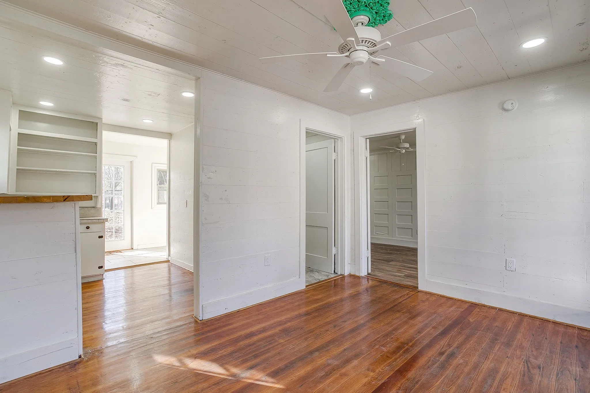 Unfurnished bedroom featuring hardwood / wood-style flooring, recessed lighting, a ceiling fan, wooden ceiling, and a spacious closet