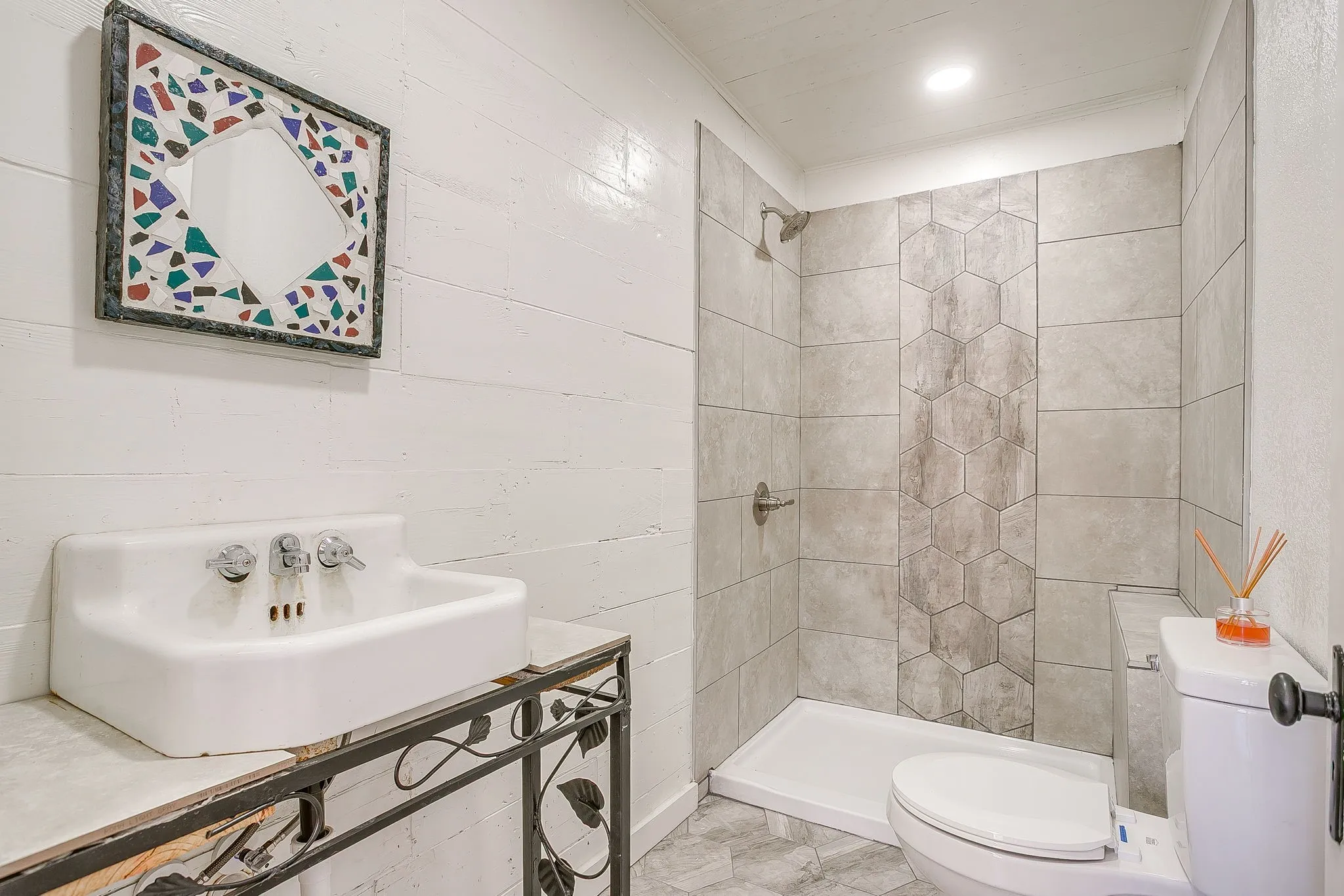Bathroom featuring a shower stall, vanity, and marble finish flooring