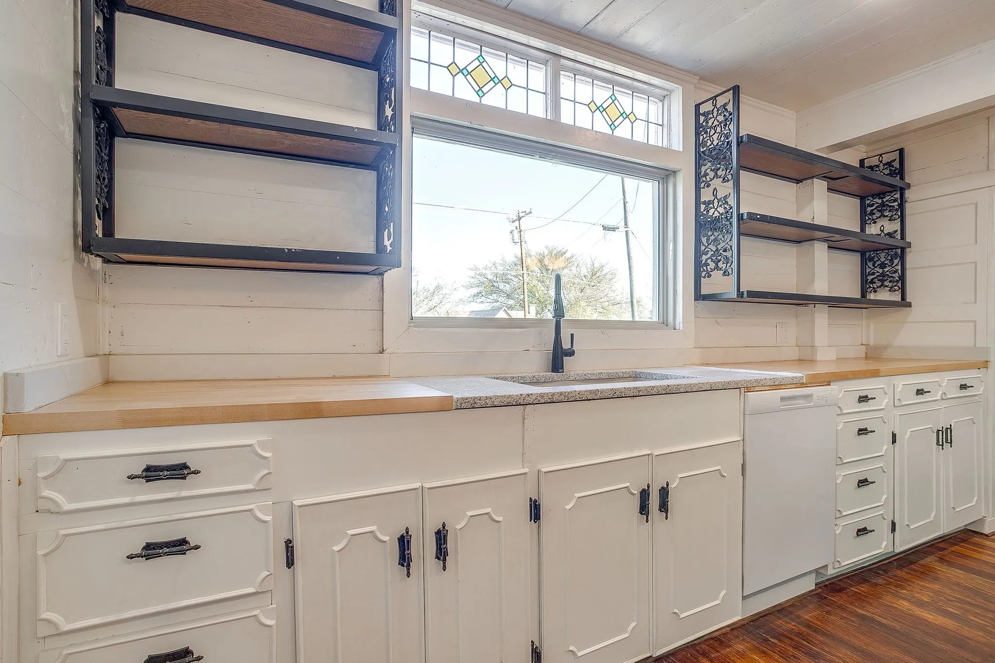 Kitchen with open shelves, white cabinetry, wood counters, white dishwasher, and dark wood-style floors
