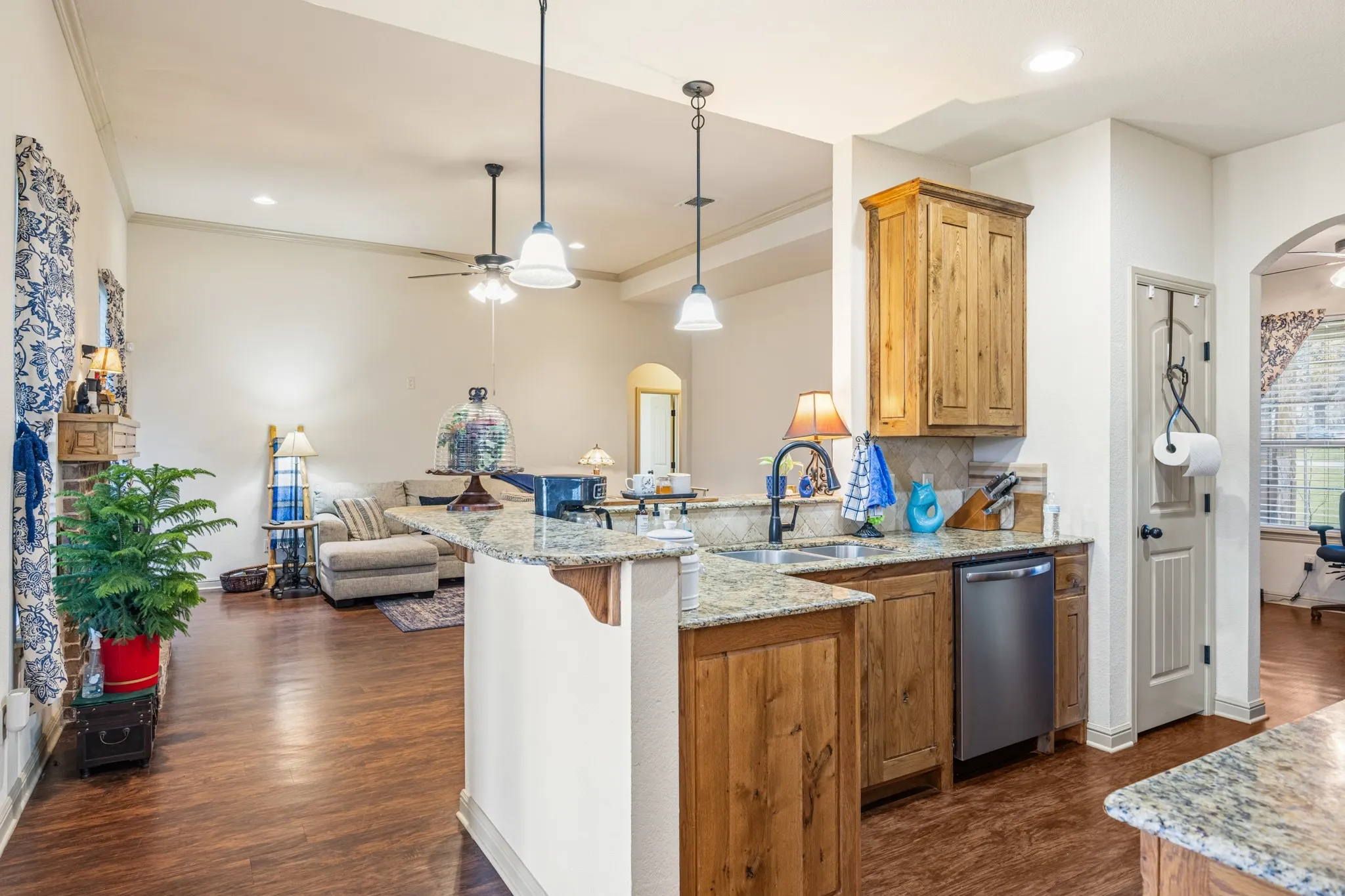 Kitchen features a closet pantry and decorative light pendants.