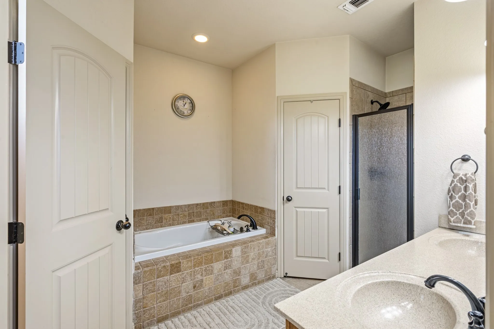 Primary bathroom features separate shower and tub as well as double sinks.