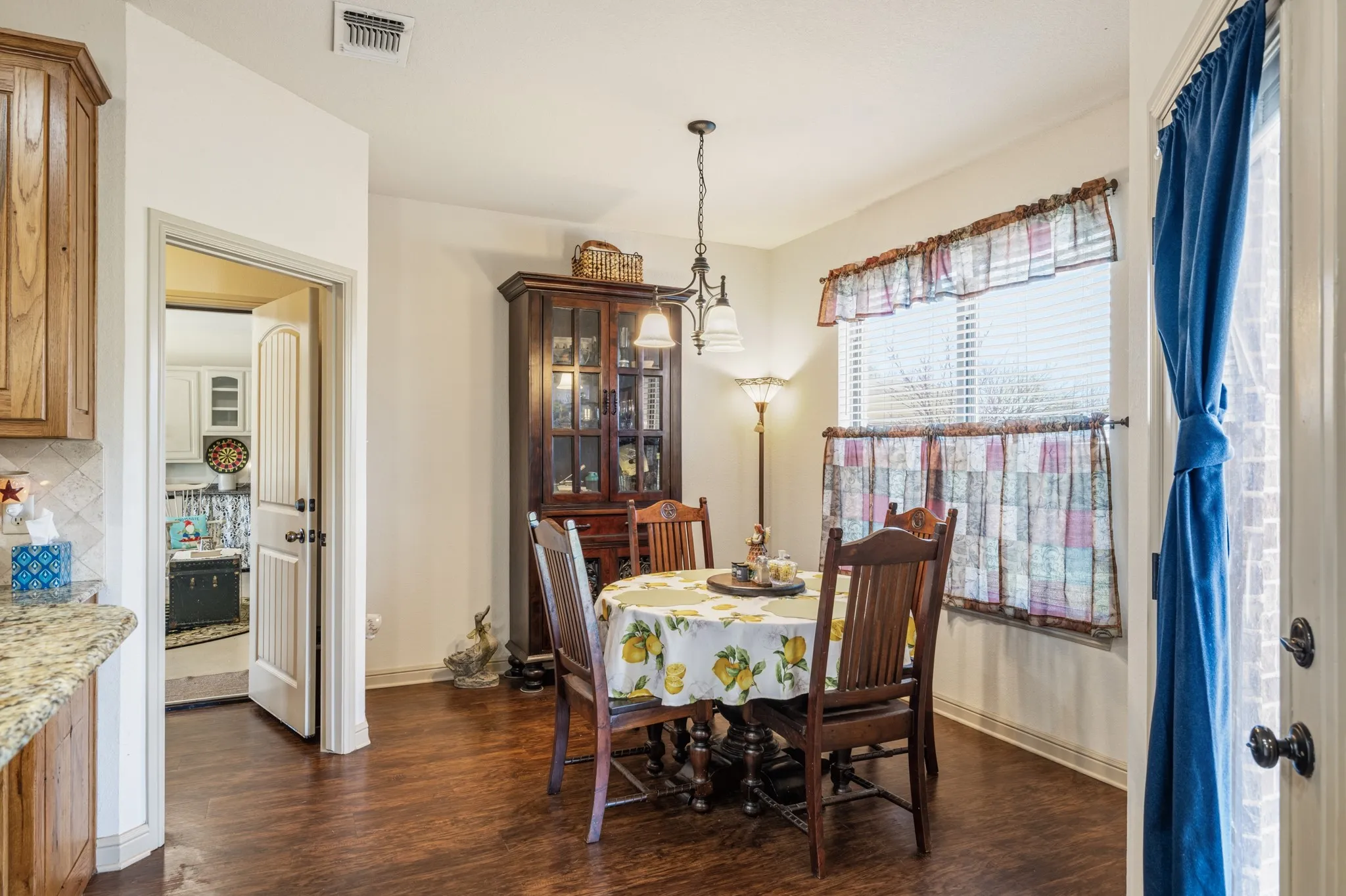 Living room leads into dining area that features a large window.