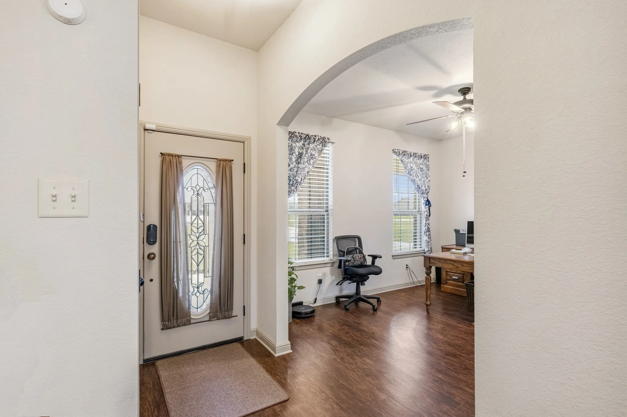 Front door with in-laid glass leads you into the home where there is a space for an office or a formal living or dining area.