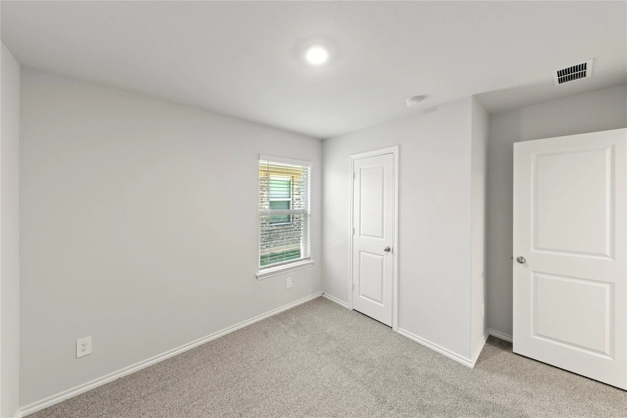 Neutral-toned carpeting throughout
