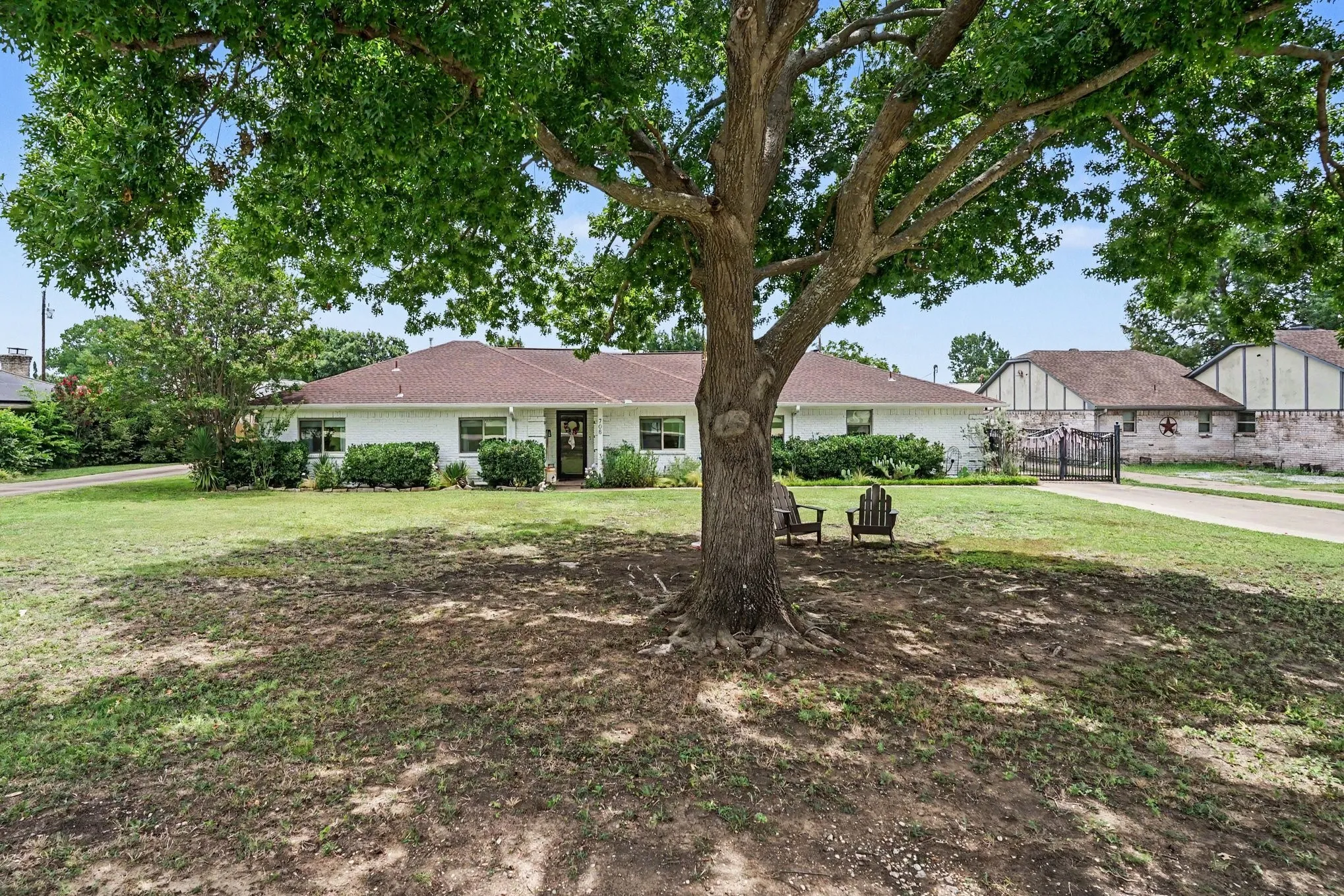 708 Summer Place, sits back on the property. Lovely Shade tree in front.