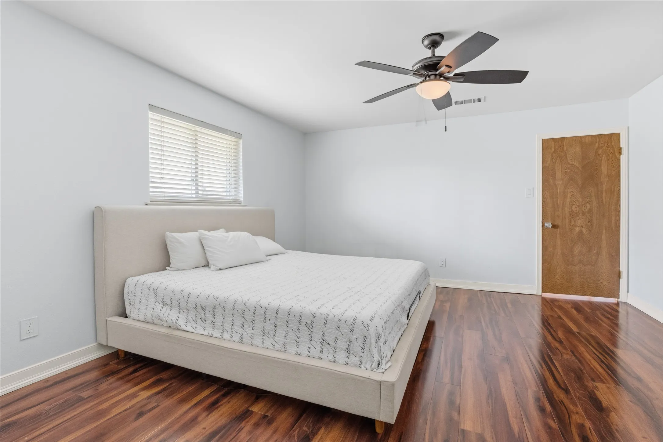 Bedroom featuring rich wood-finish flooring