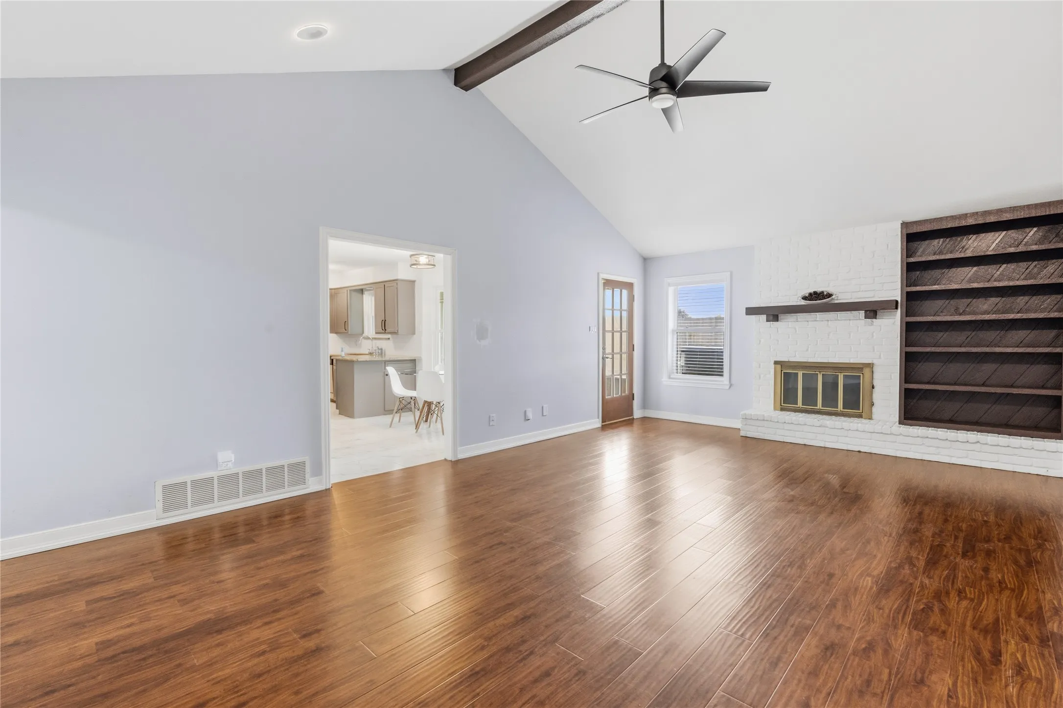 Vaulted ceiling with exposed beam and ceiling fan