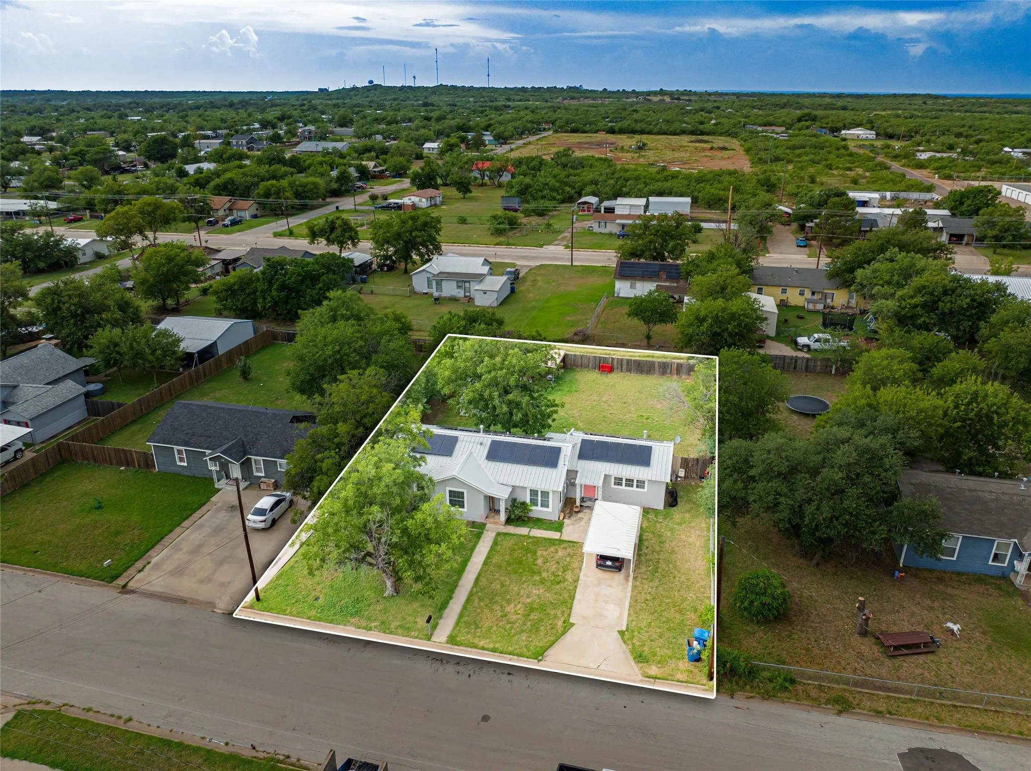 Single-story residence featuring a metal roof and an attached carport