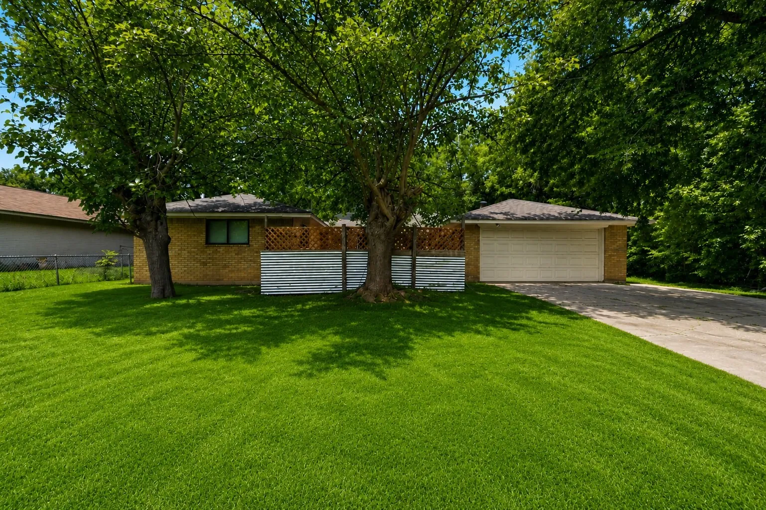 Expansive green lawn with mature shade trees